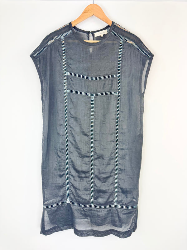 Blue denim dress on a wooden hanger against a white background