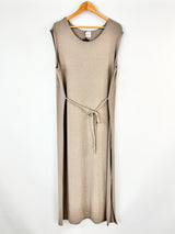 Beige sleeveless dress on a hanger against a white background
