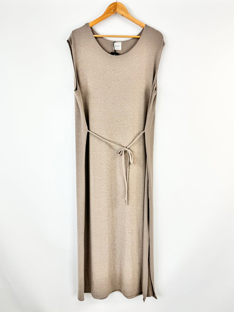 Beige sleeveless dress on a hanger against a white background