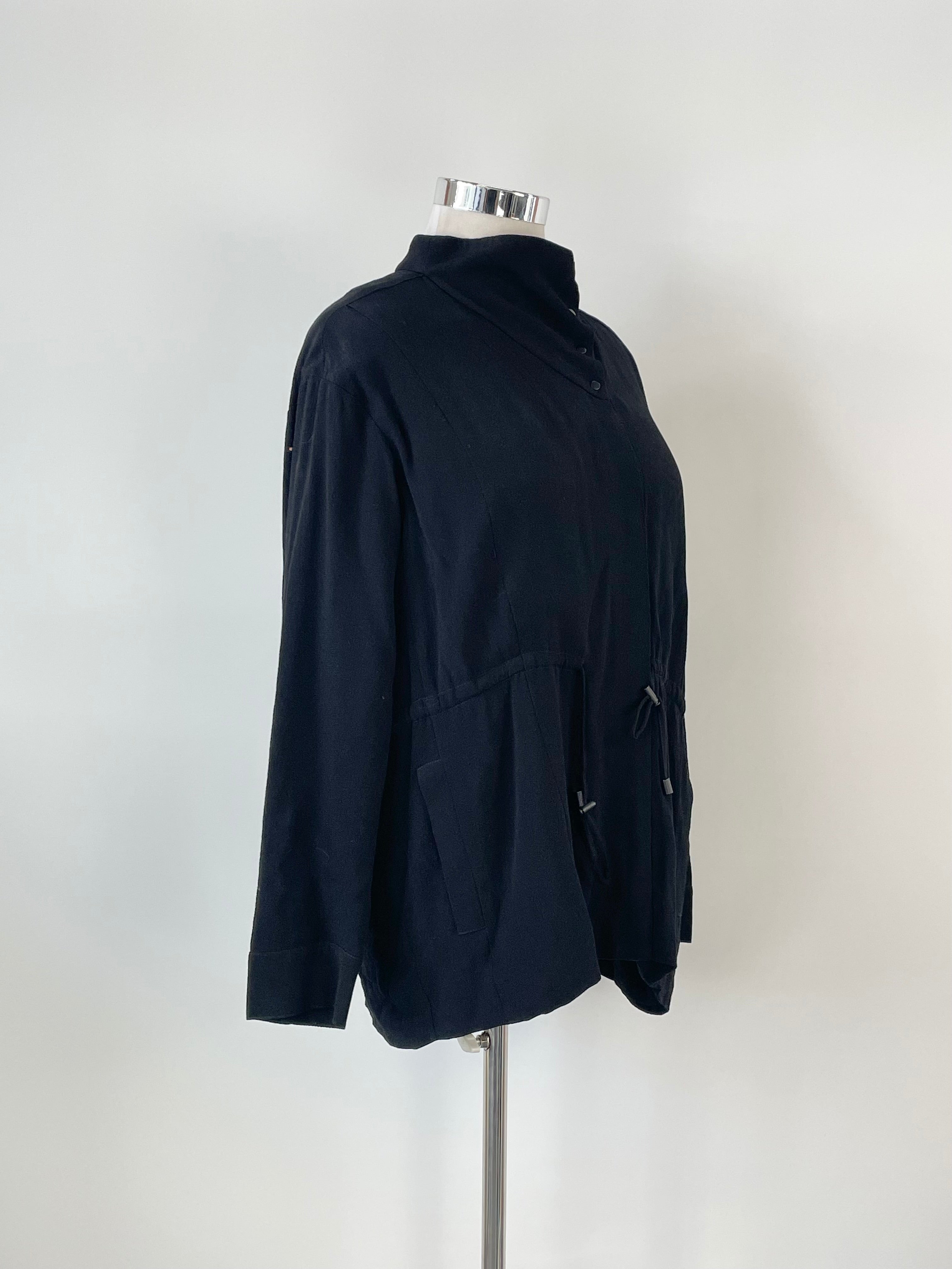 Black long-sleeved button-up top displayed on a mannequin against a white background.