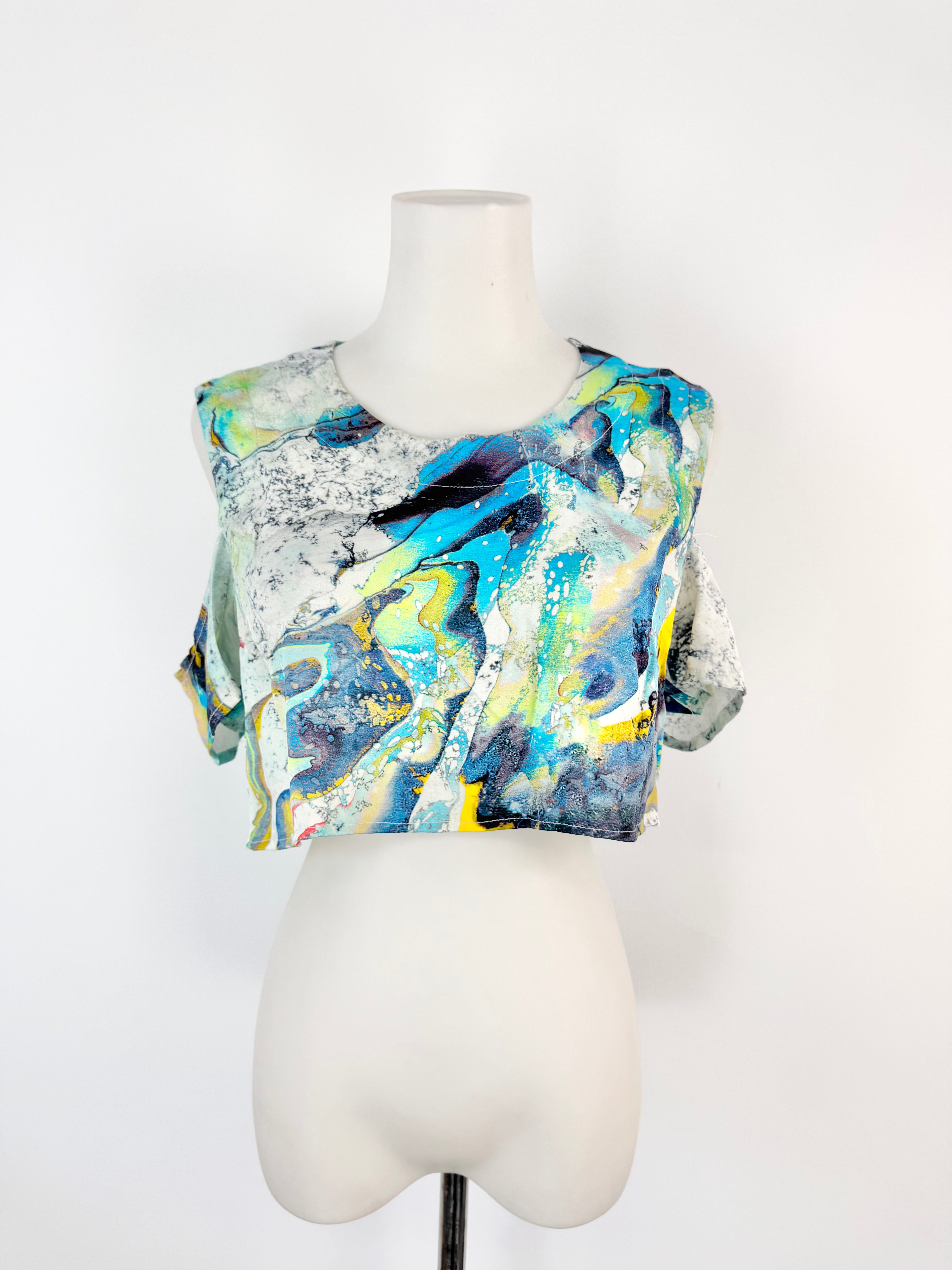 Abstract patterned top on a mannequin against a white background