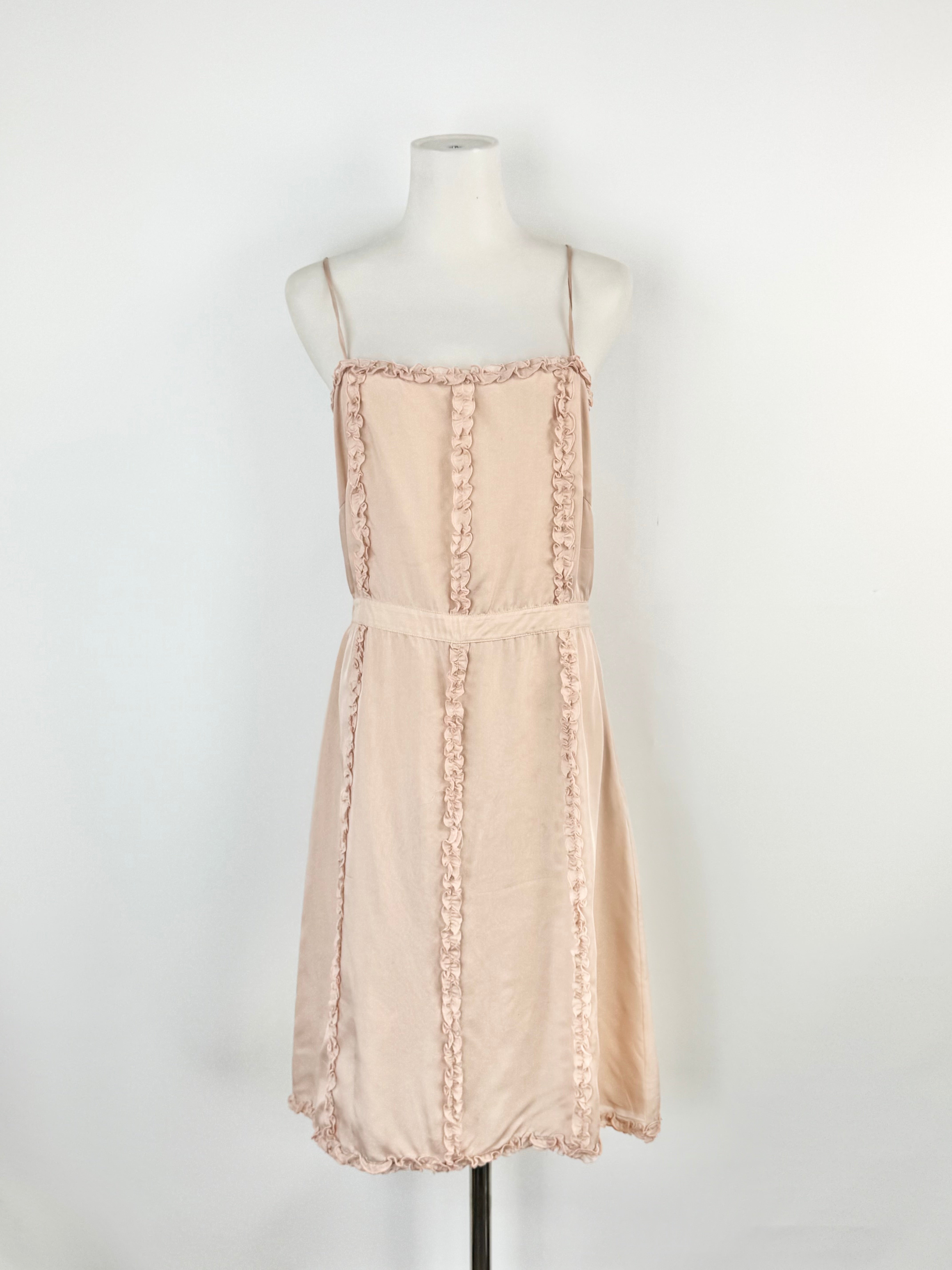 Beige dress on a mannequin against a white background