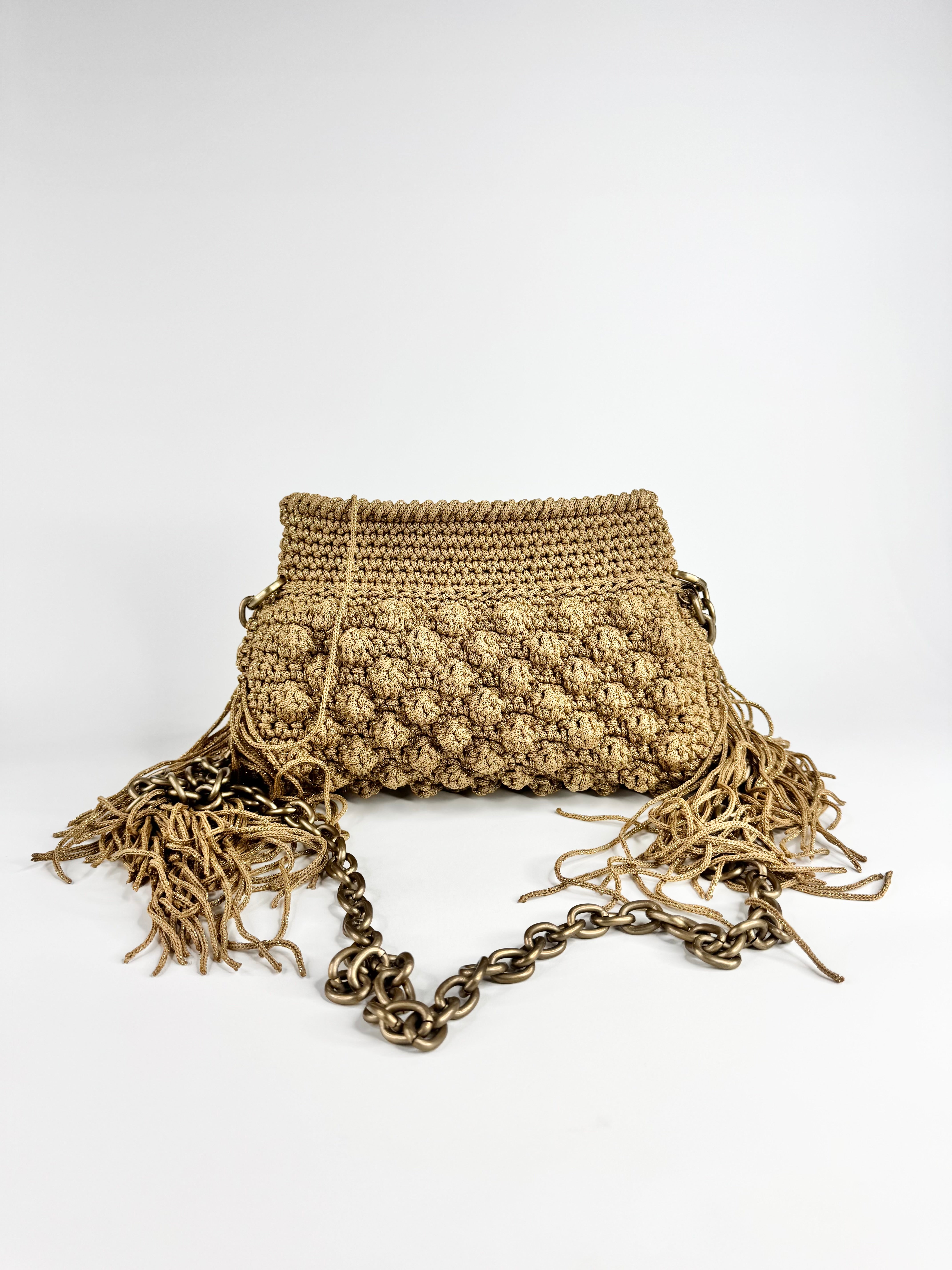 Crocheted bag with chain detail on a white background
