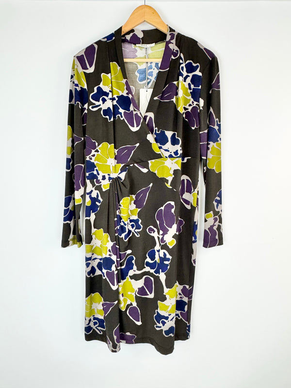 Floral-patterned dress on a hanger against a white background