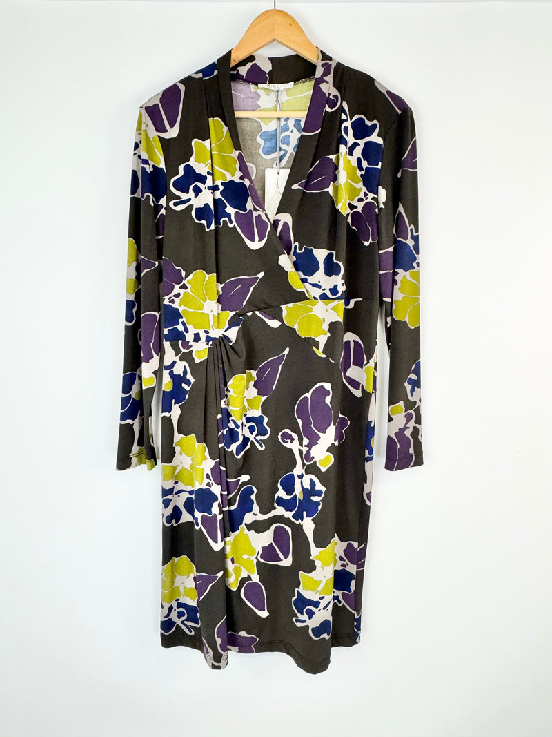 Floral-patterned dress on a hanger against a white background