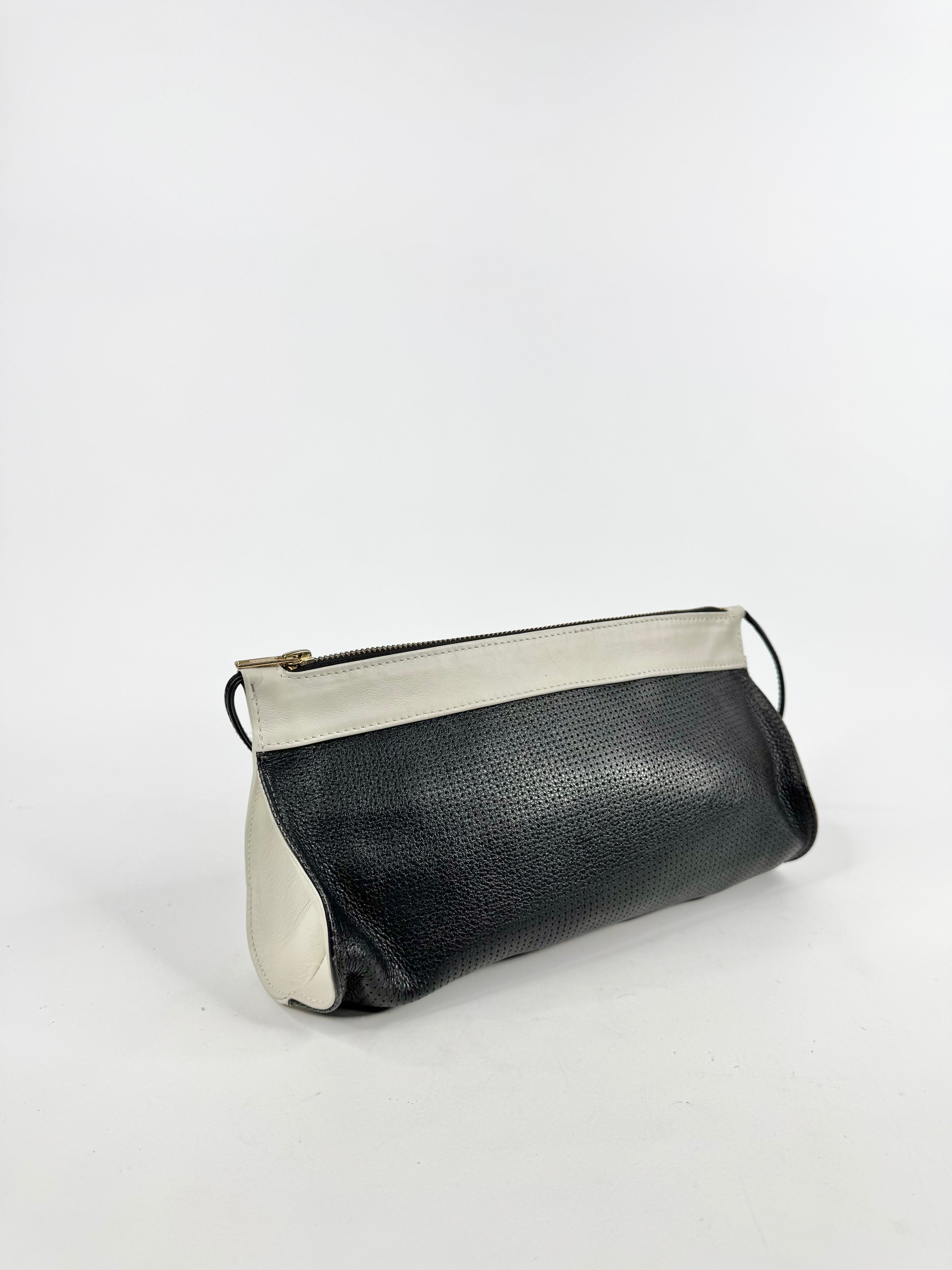 Black and white clutch bag on a light gray background
