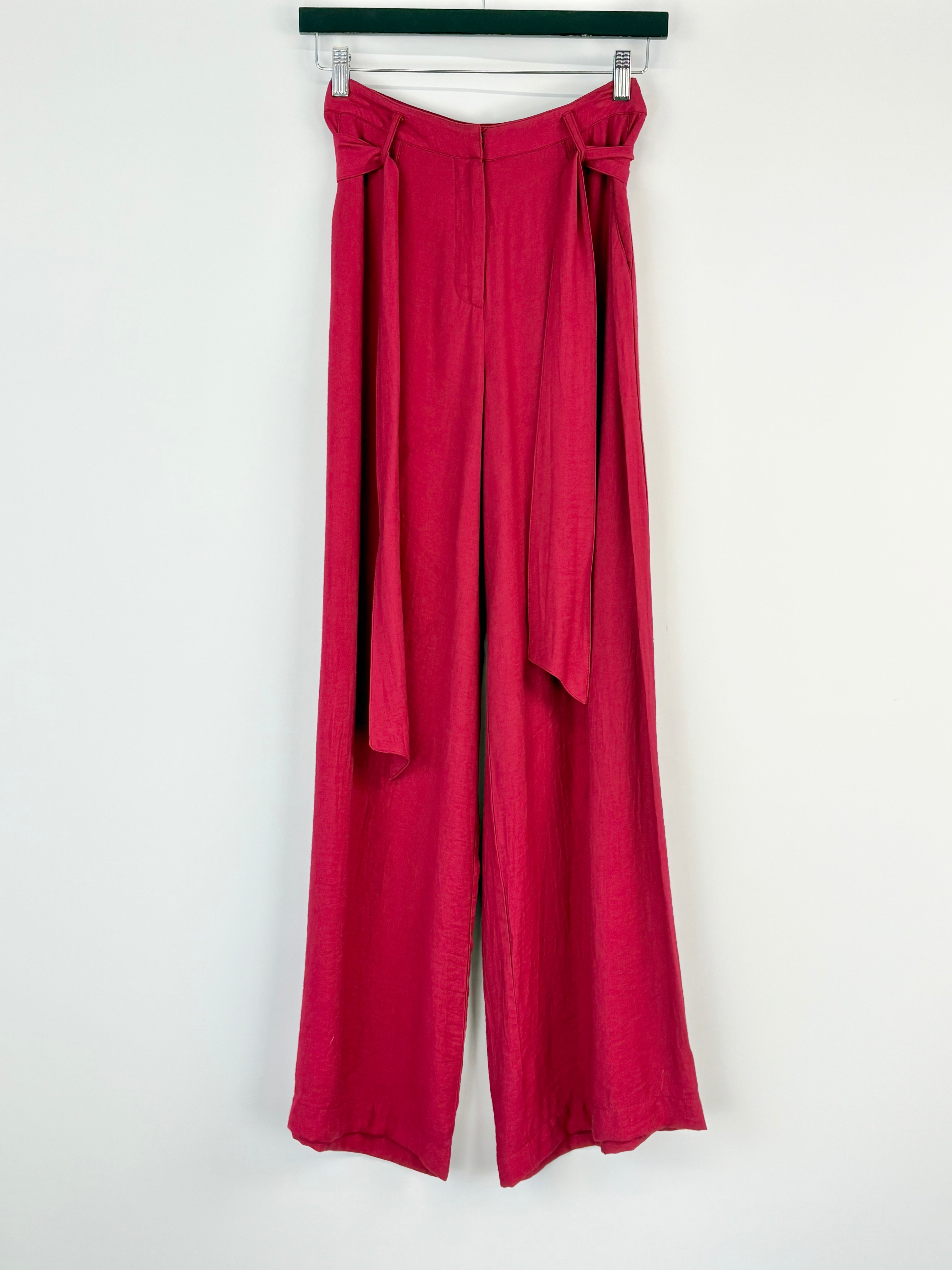 Red pants with a tie waist on a white background