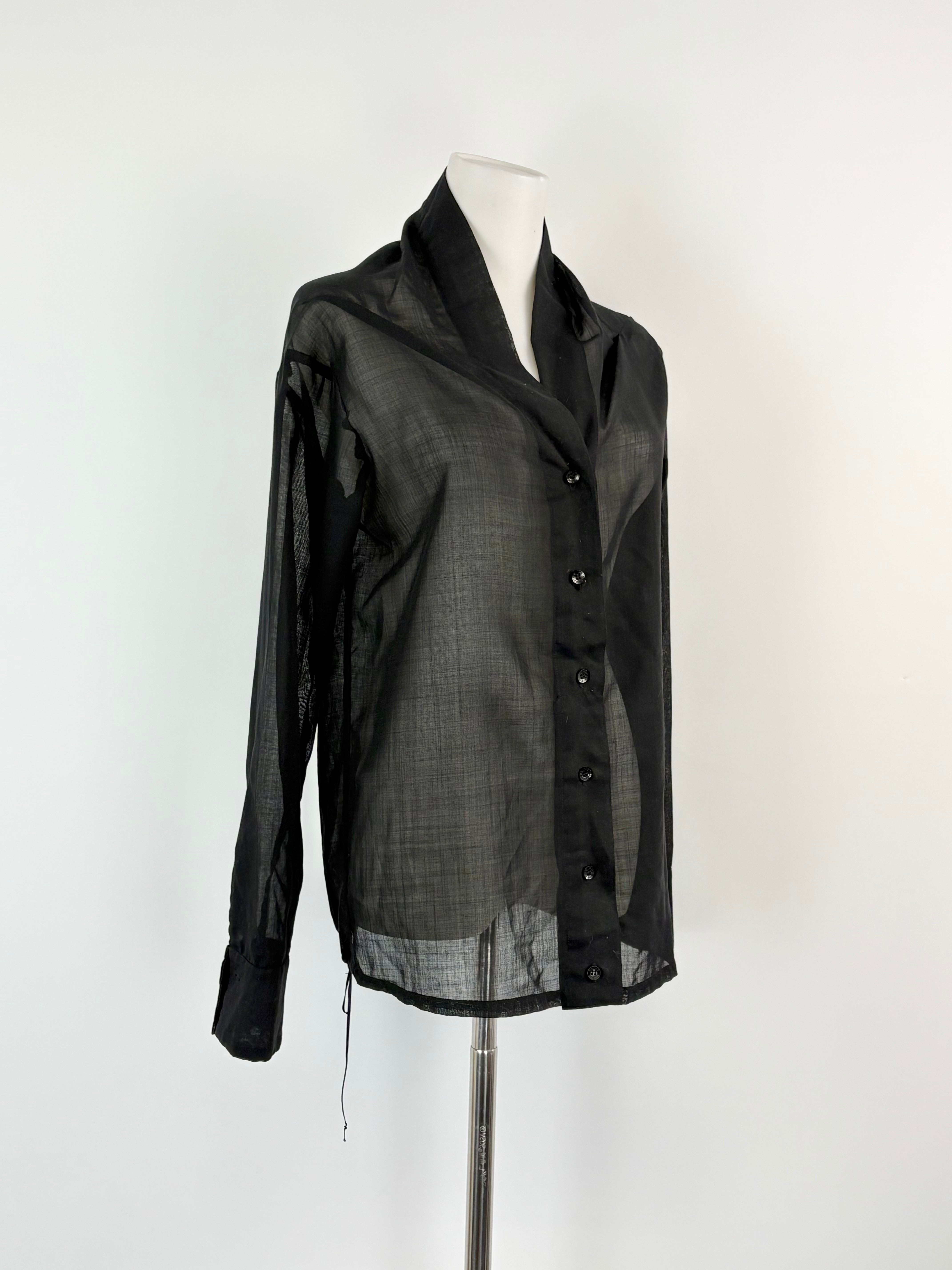 Black shirt on a mannequin against a white background