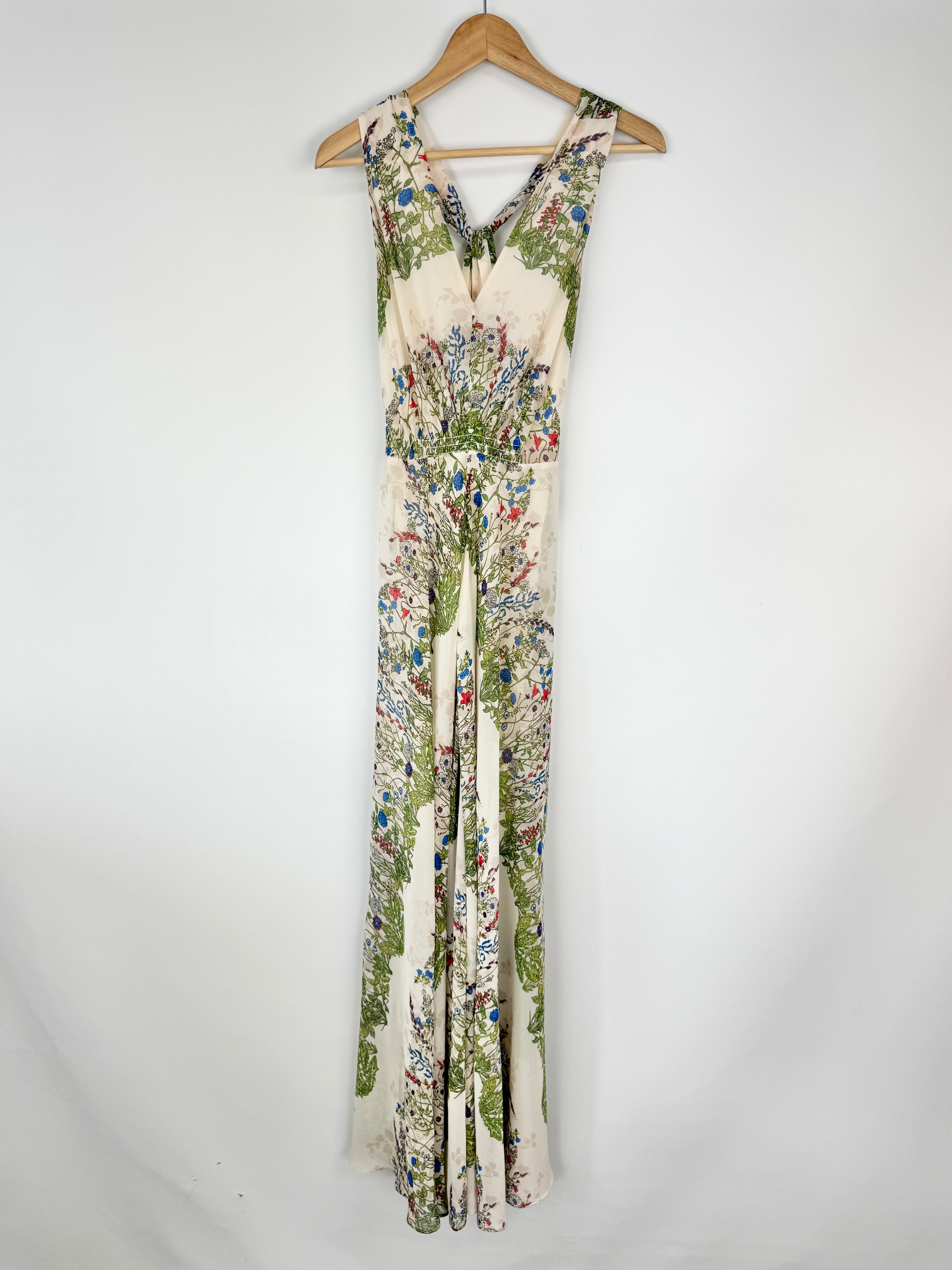 Floral-patterned dress on a hanger against a white background