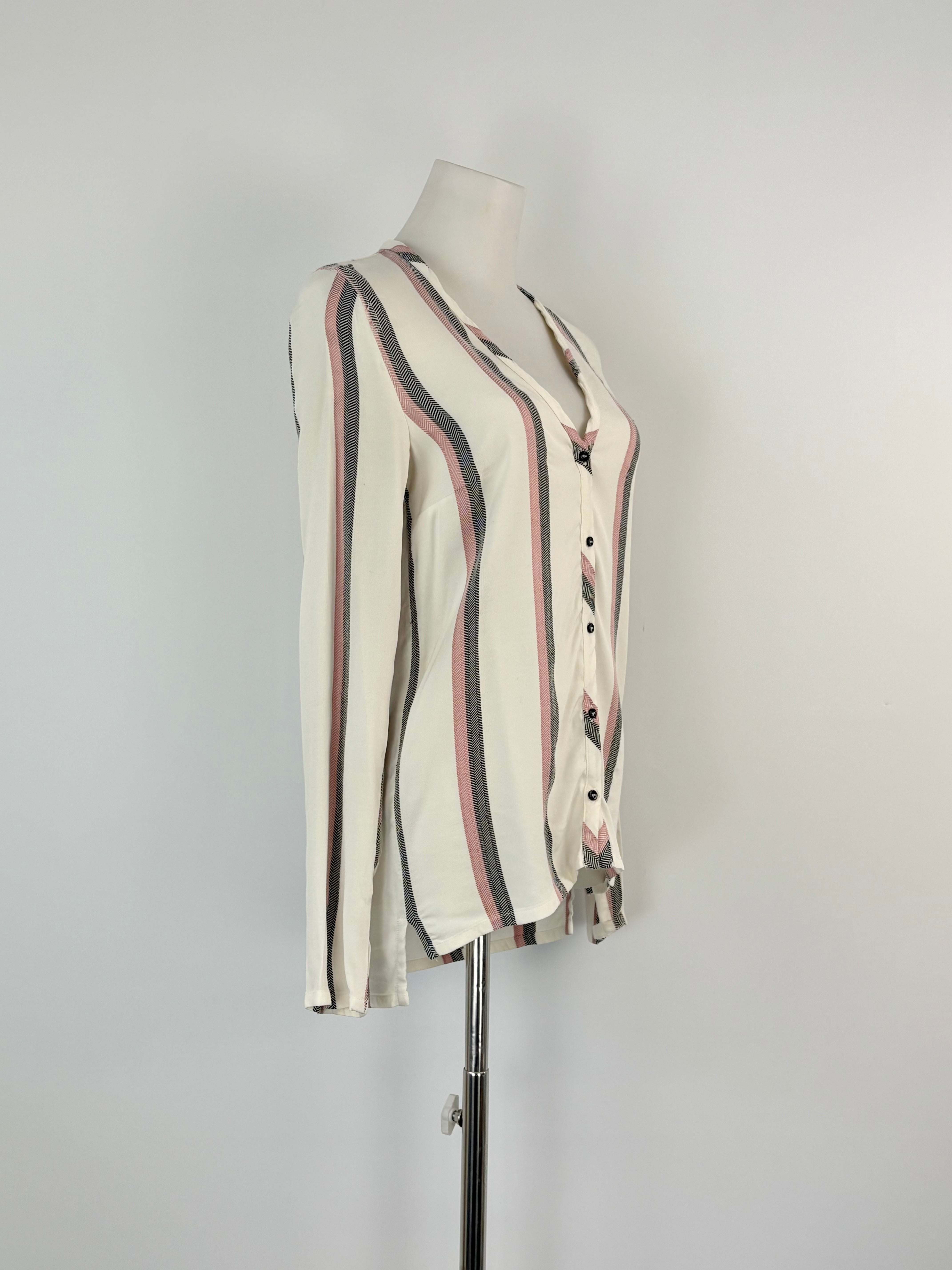 Striped shirt on a mannequin against a plain background