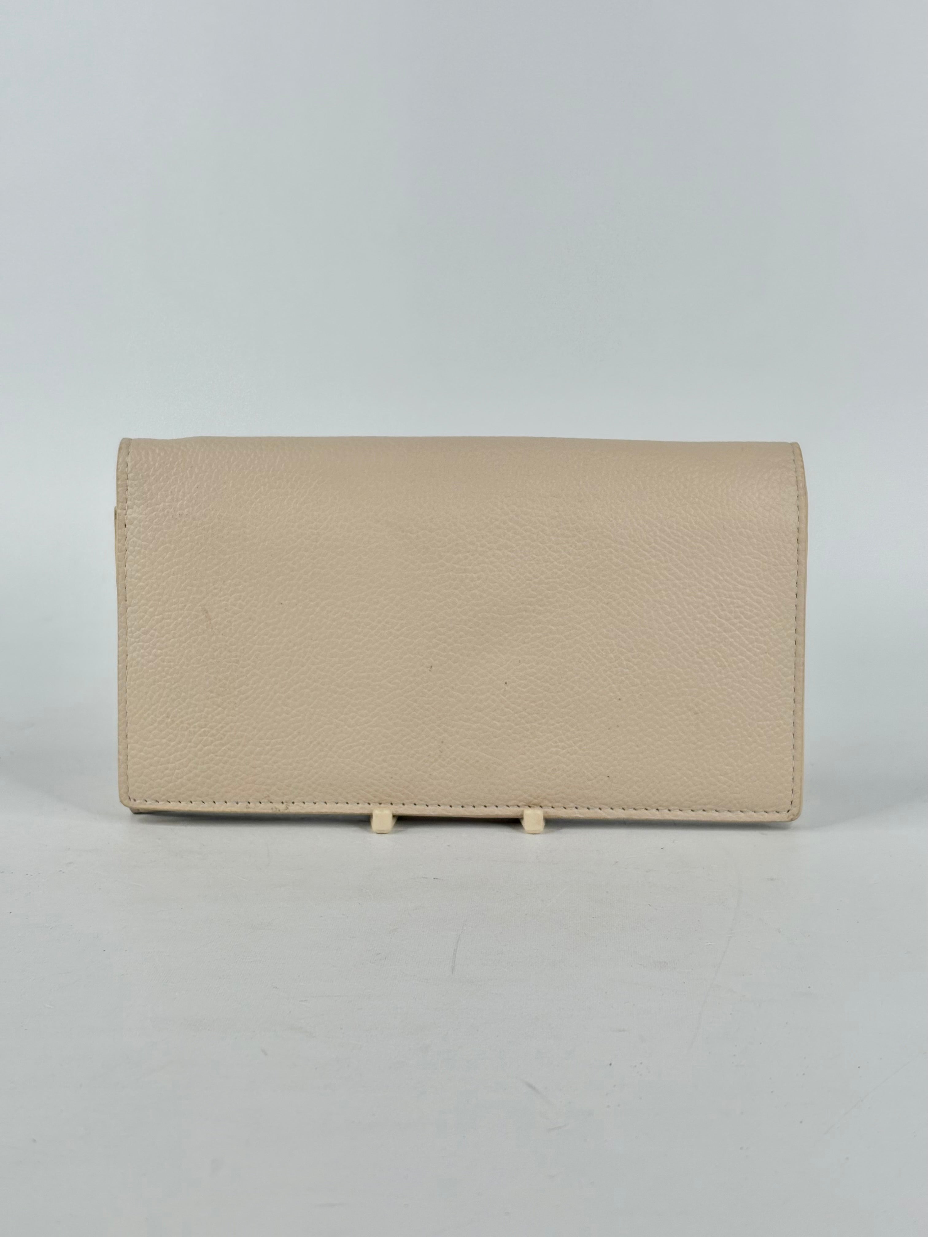 Beige wallet on a light gray background
