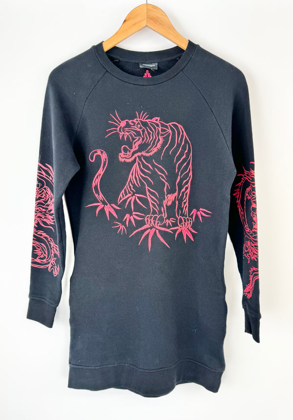 Black sweatshirt with pink tiger design on a hanger against a white background