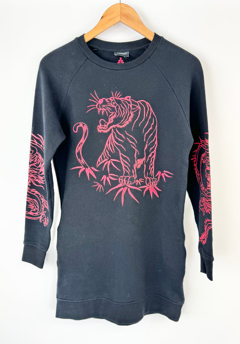 Black sweatshirt with pink tiger design on a hanger against a white background