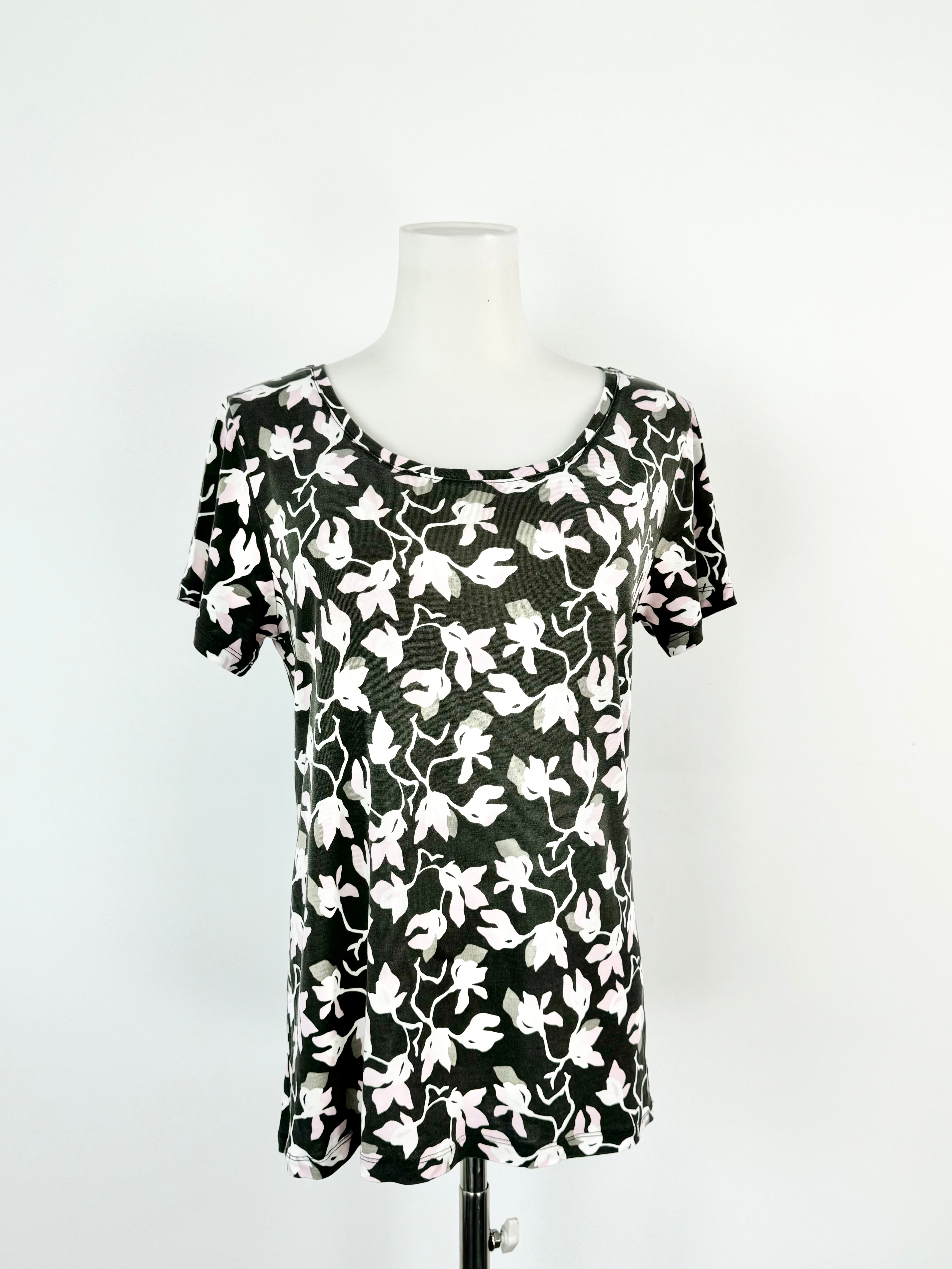 A soft grey t-shirt with a black floral 'Katleija' pattern displayed on a mannequin.