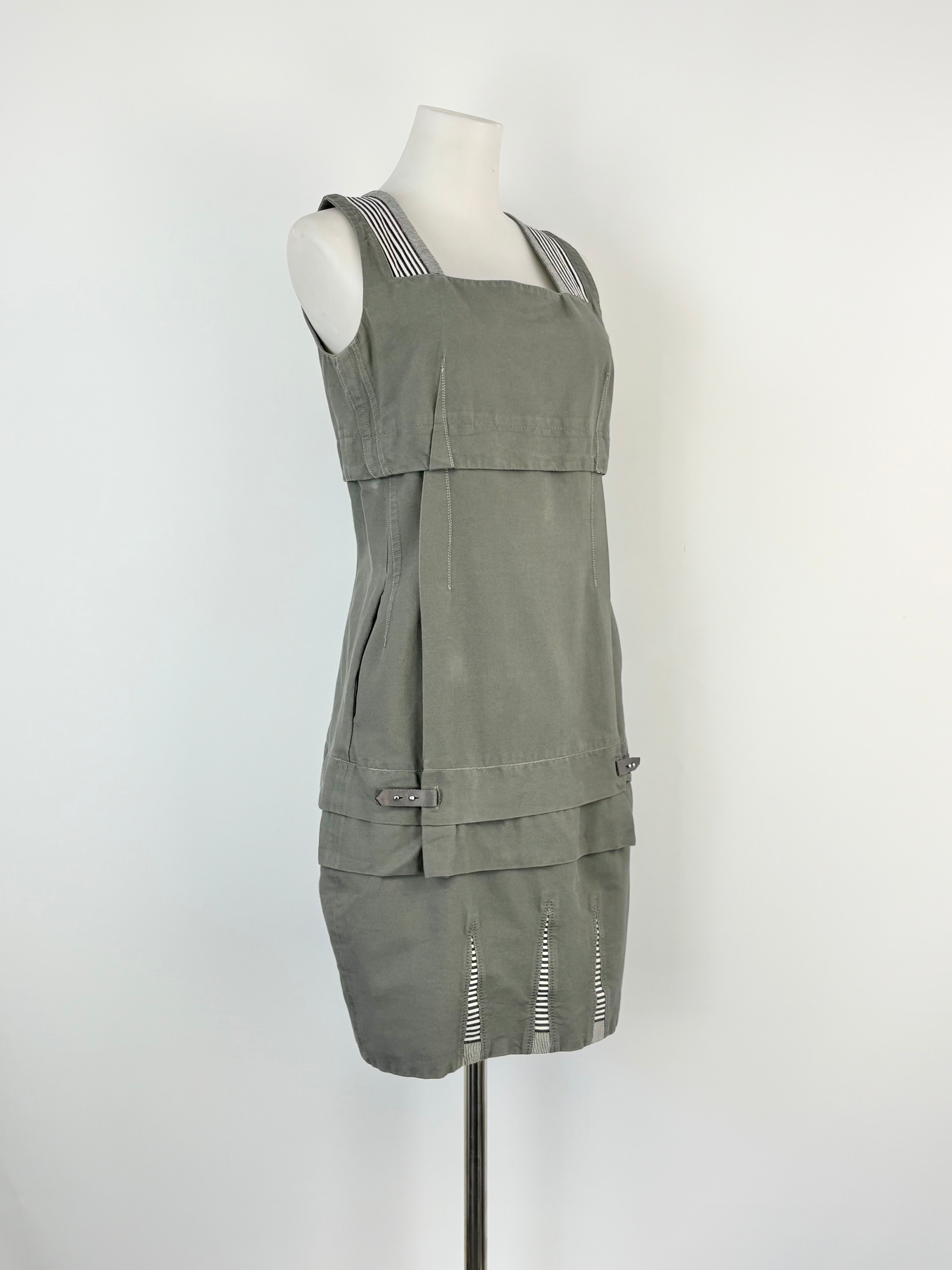 Green dress on a mannequin against a white background