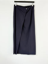 Navy blue skirt on a hanger against a white background