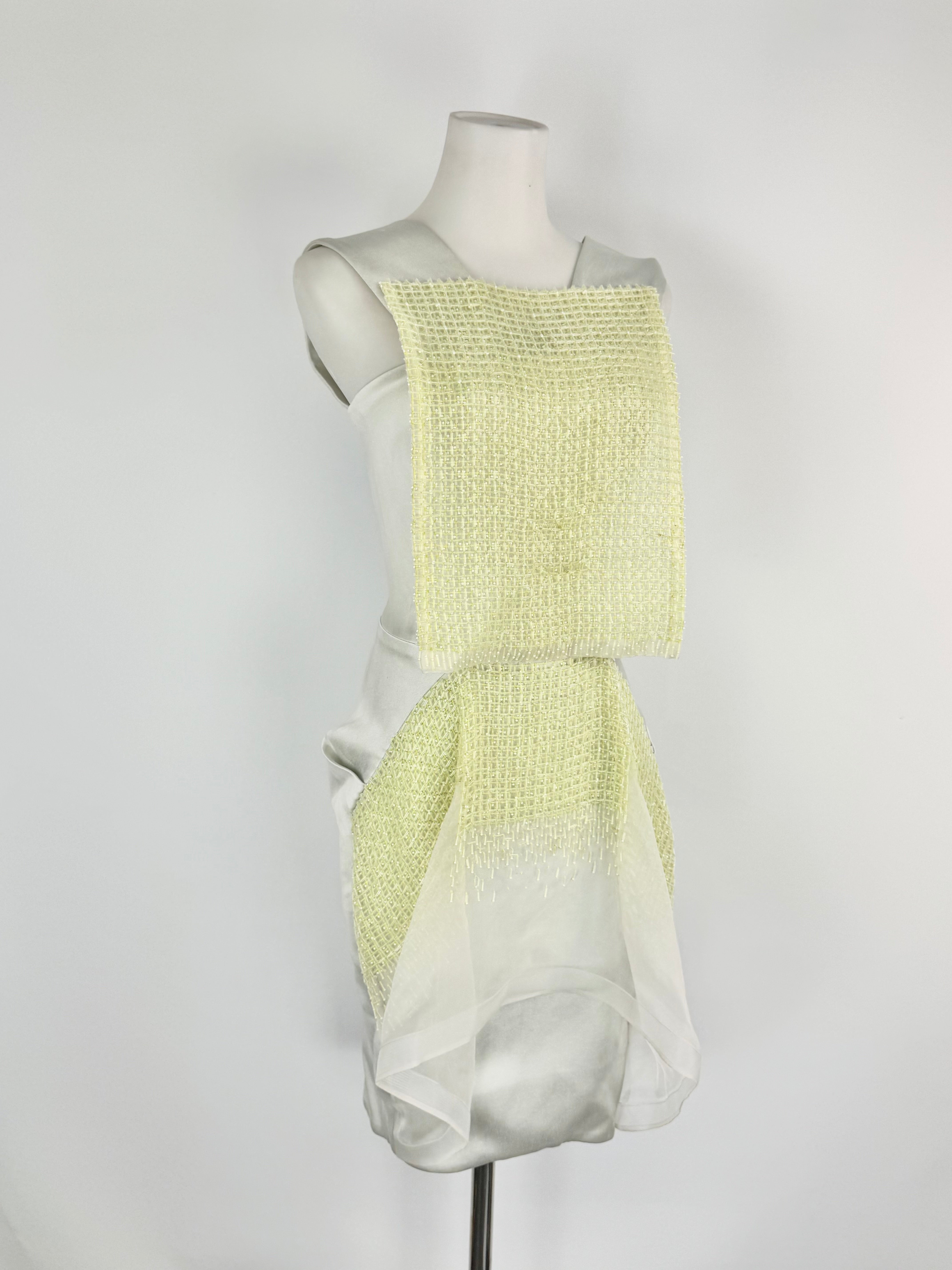 Mannequin wearing a light green and blue textured dress on a white background