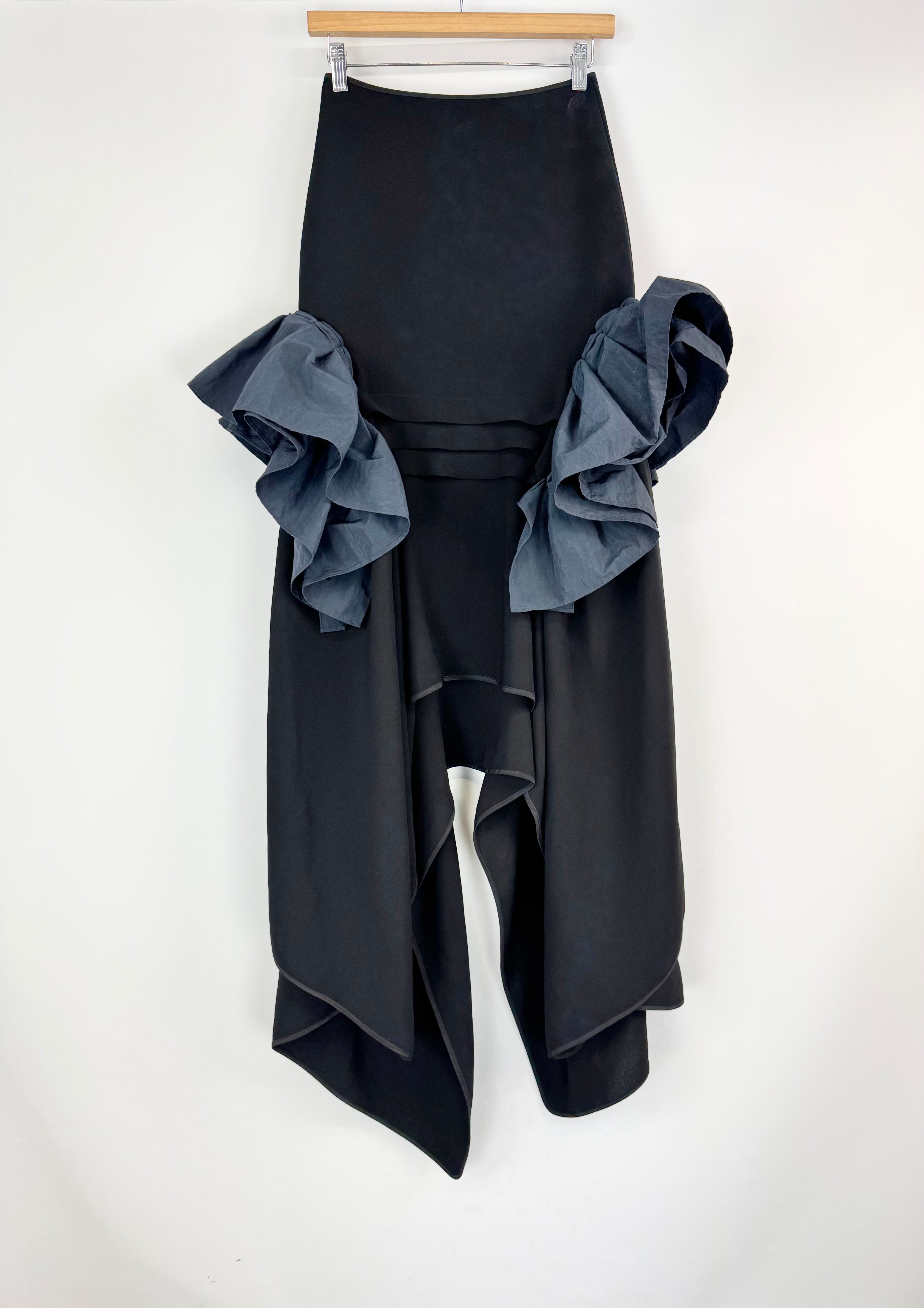 Black skirt with ruffled details on a white background