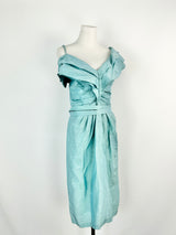 Sky blue linen and silk midi dress with off-shoulder design and pleated waist on a mannequin