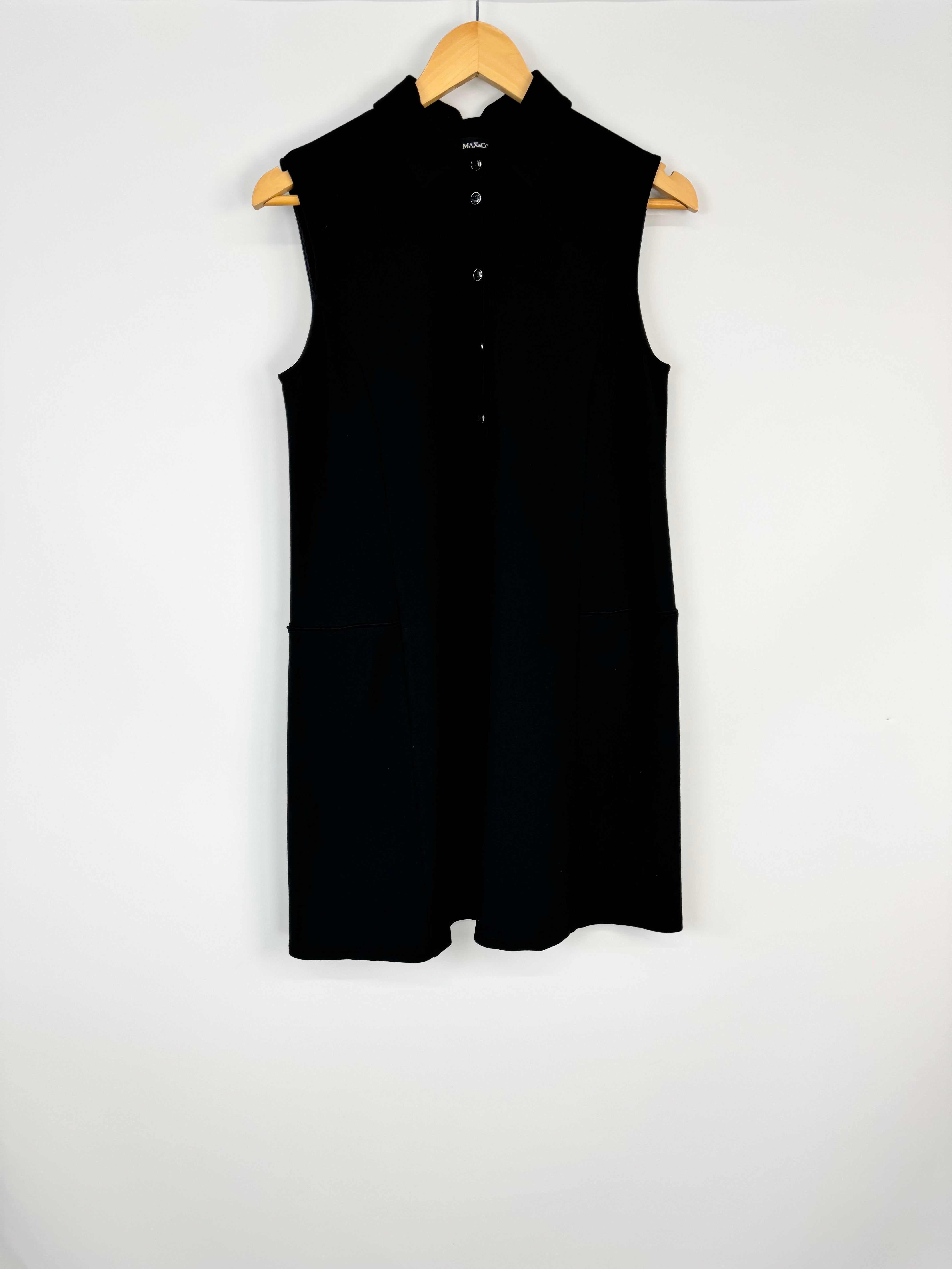 Black sleeveless dress on a wooden hanger against a white background