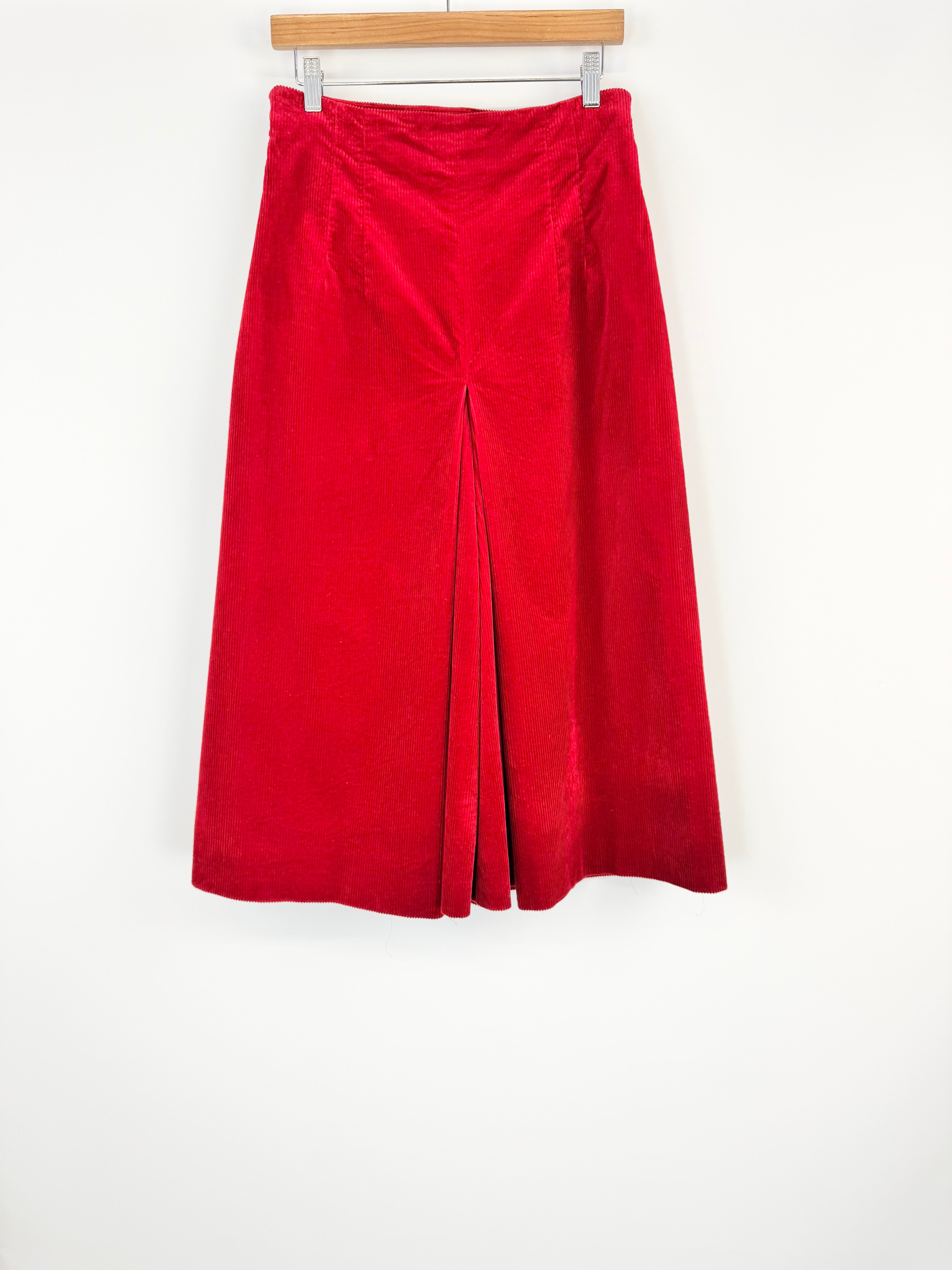 Red culottes on a hanger against a white background