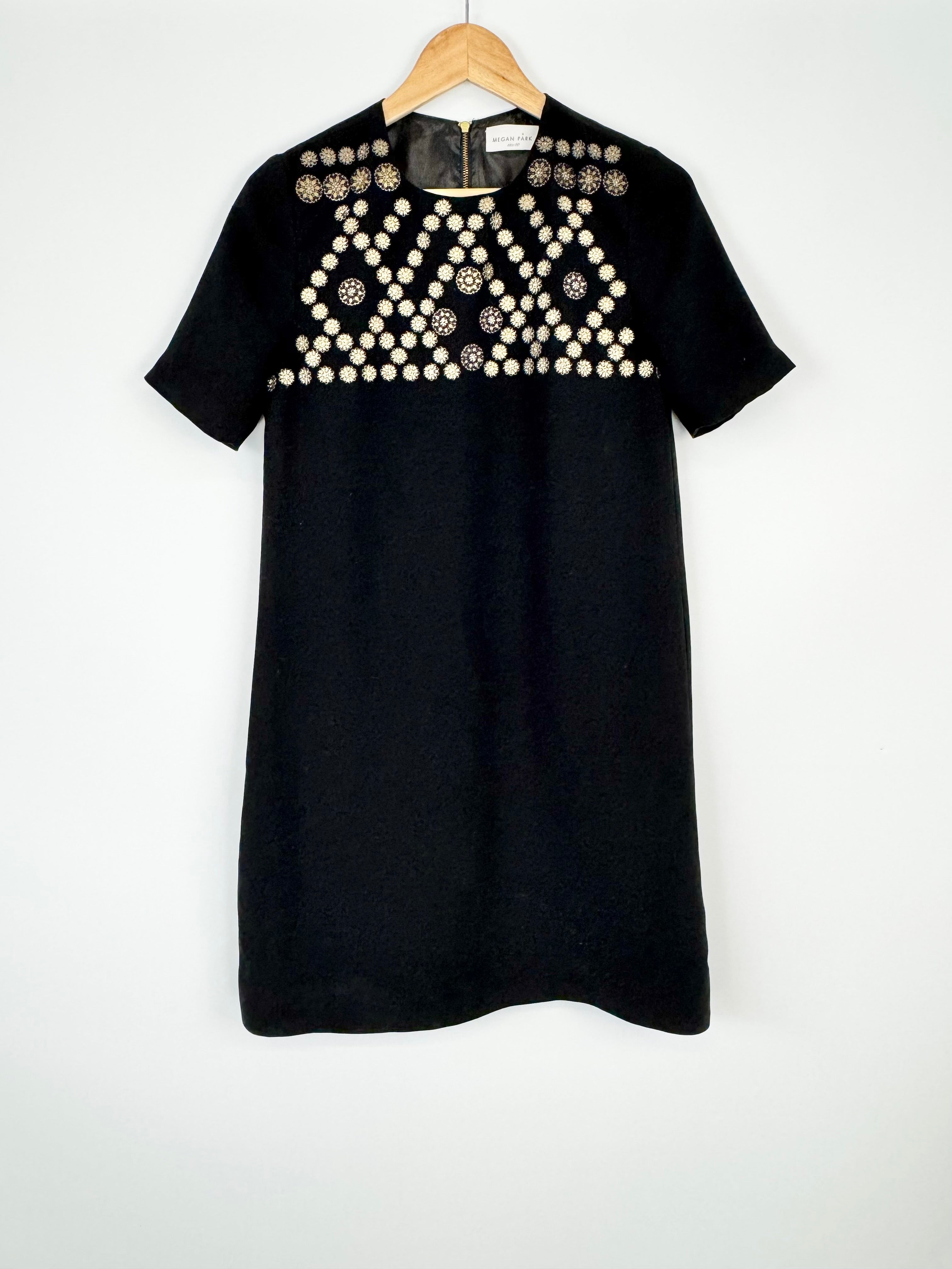 Black dress with decorative elements on a white background