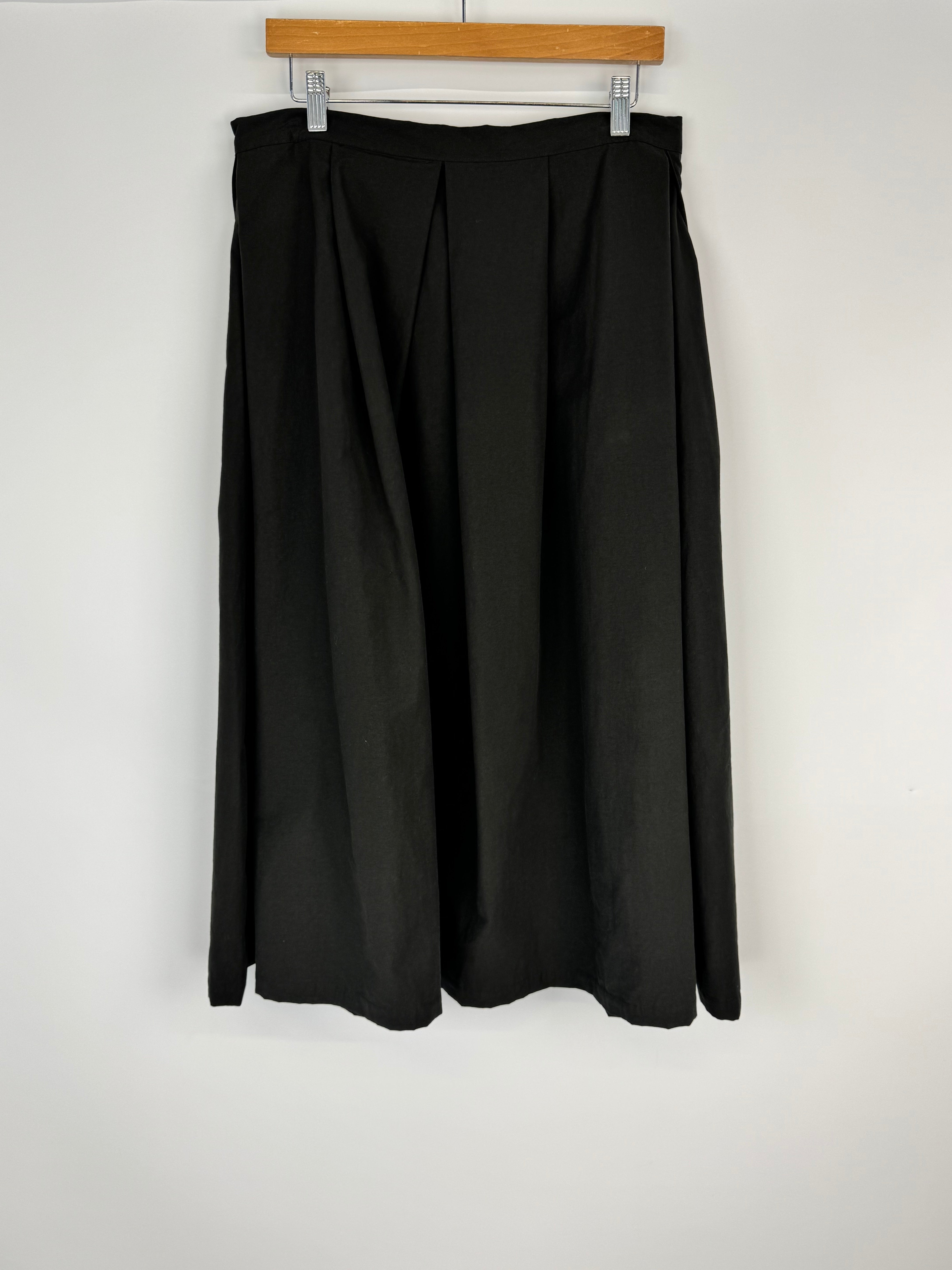 Black skirt on a hanger against a white background