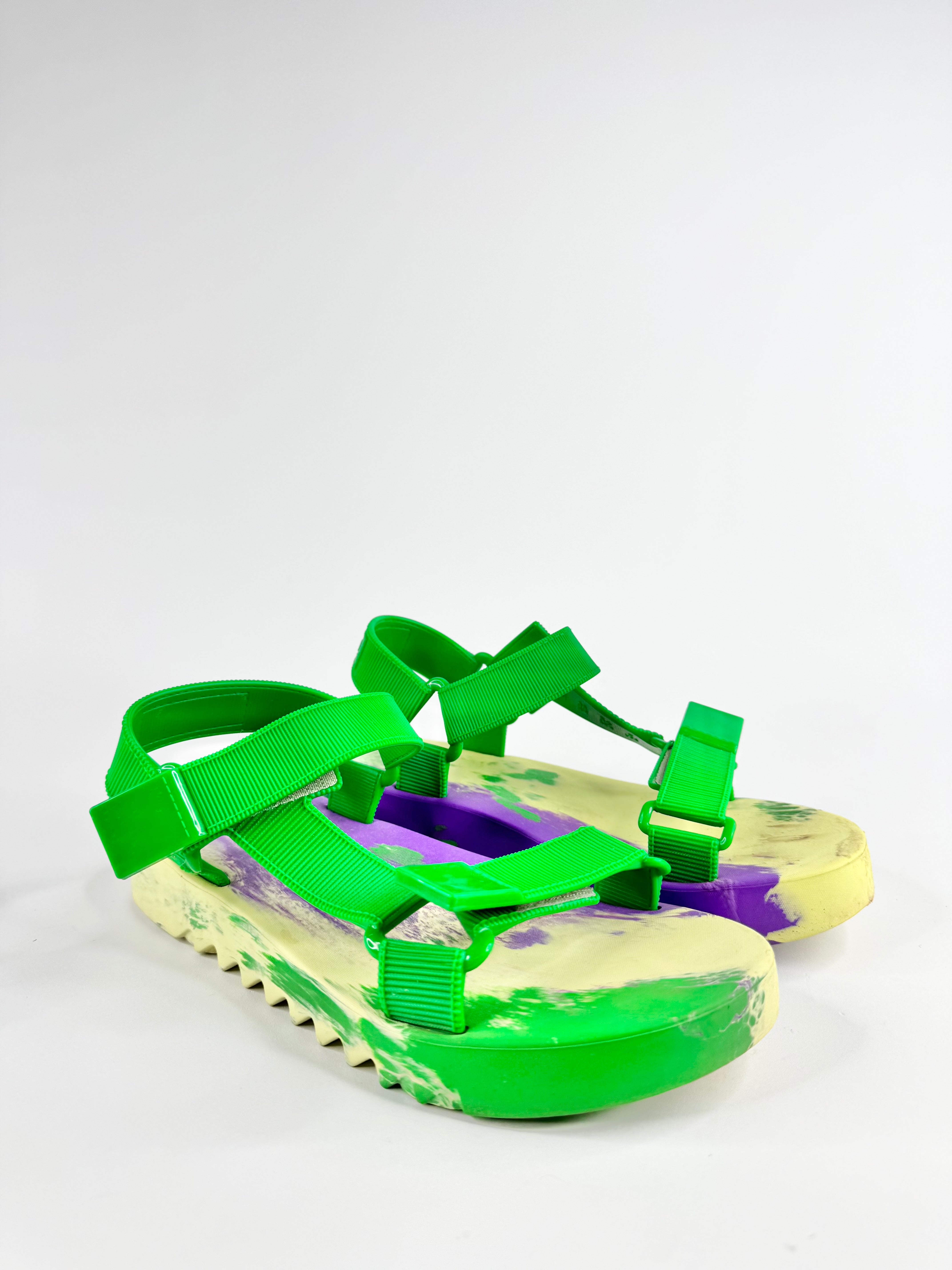 Green and purple sandal with a white sole on a light gray background