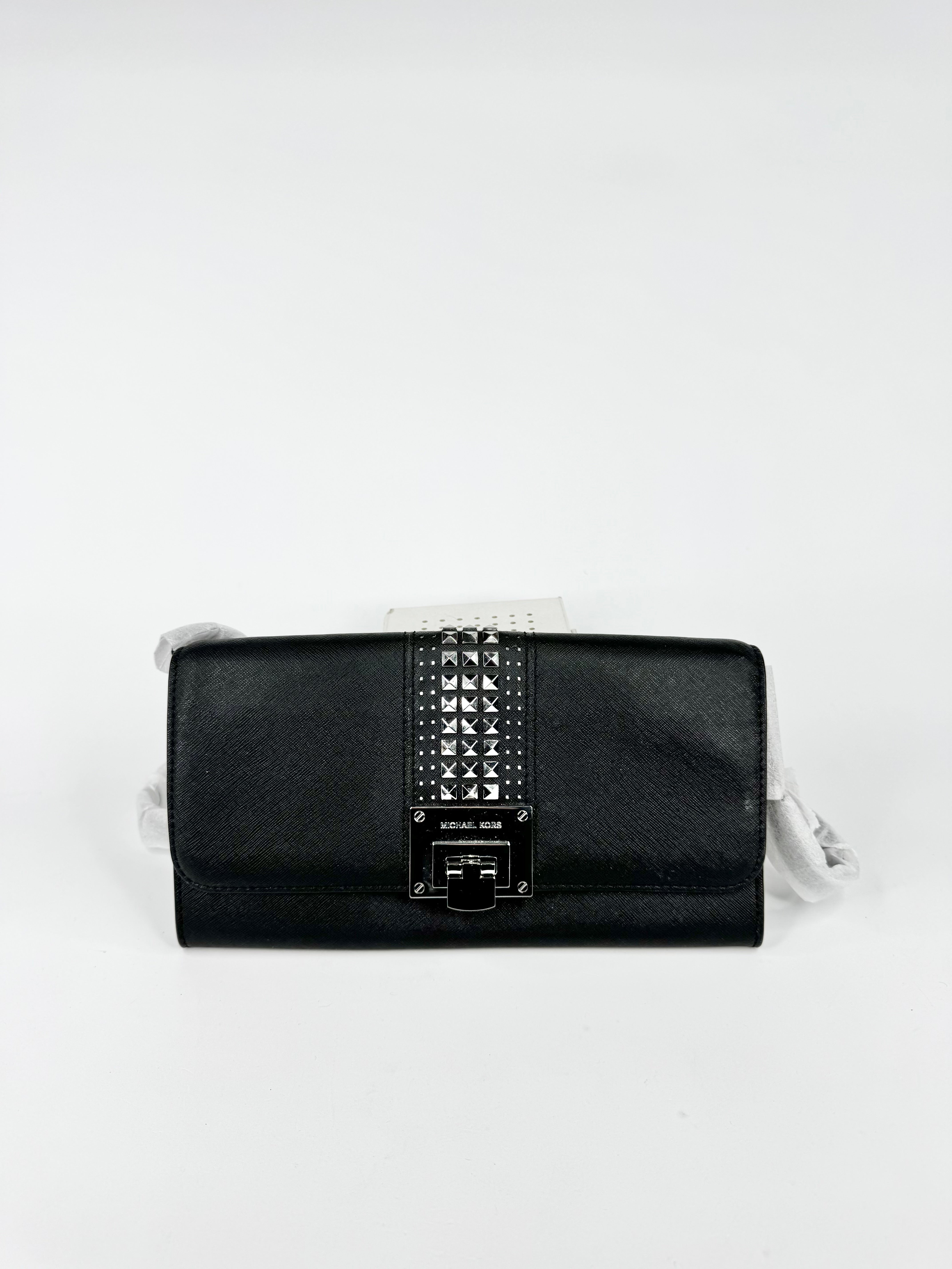Black clutch bag with studded detail on a white background