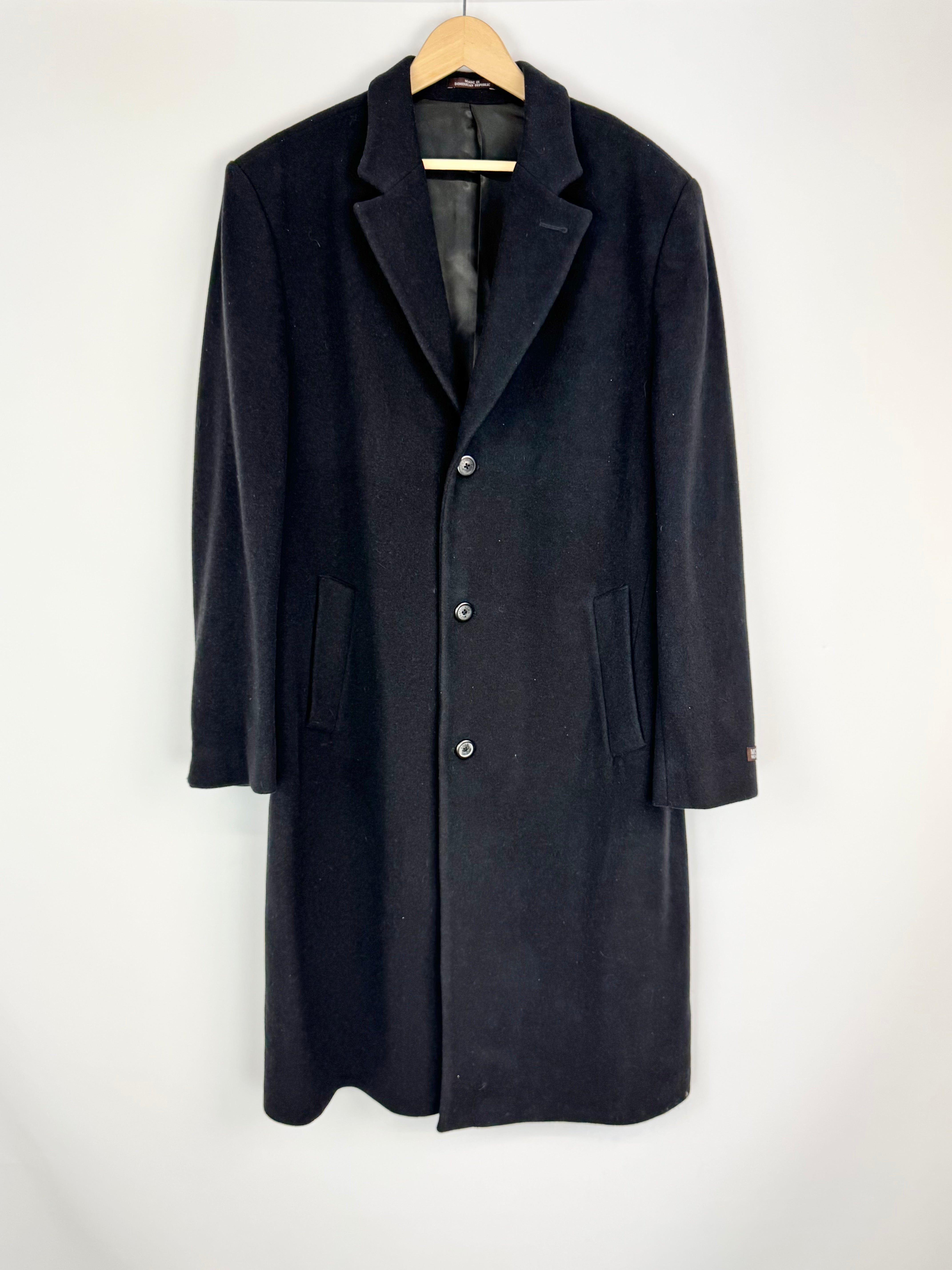 Black coat on a hanger against a white background