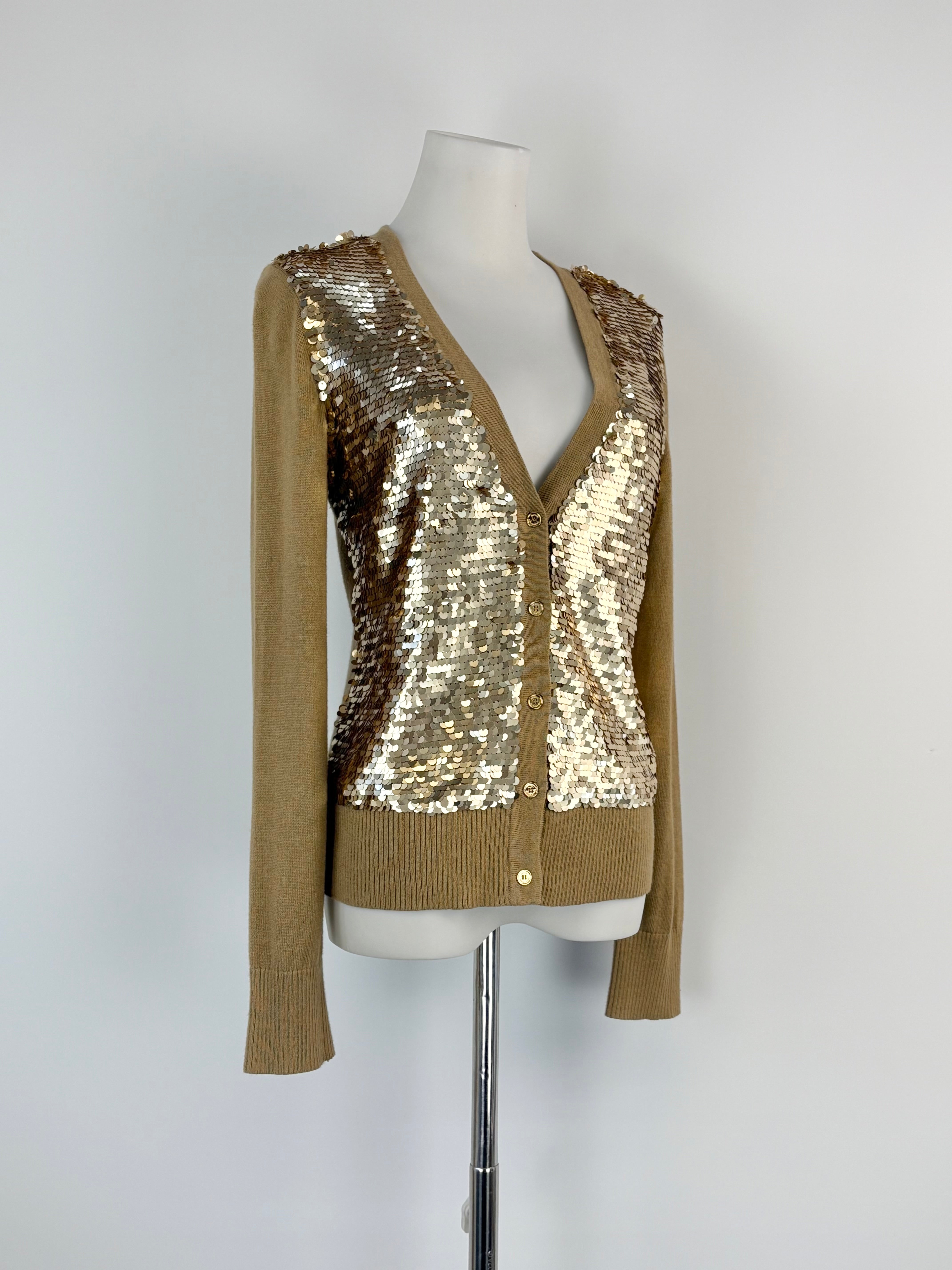 Mannequin wearing a gold sequin cardigan on a white background