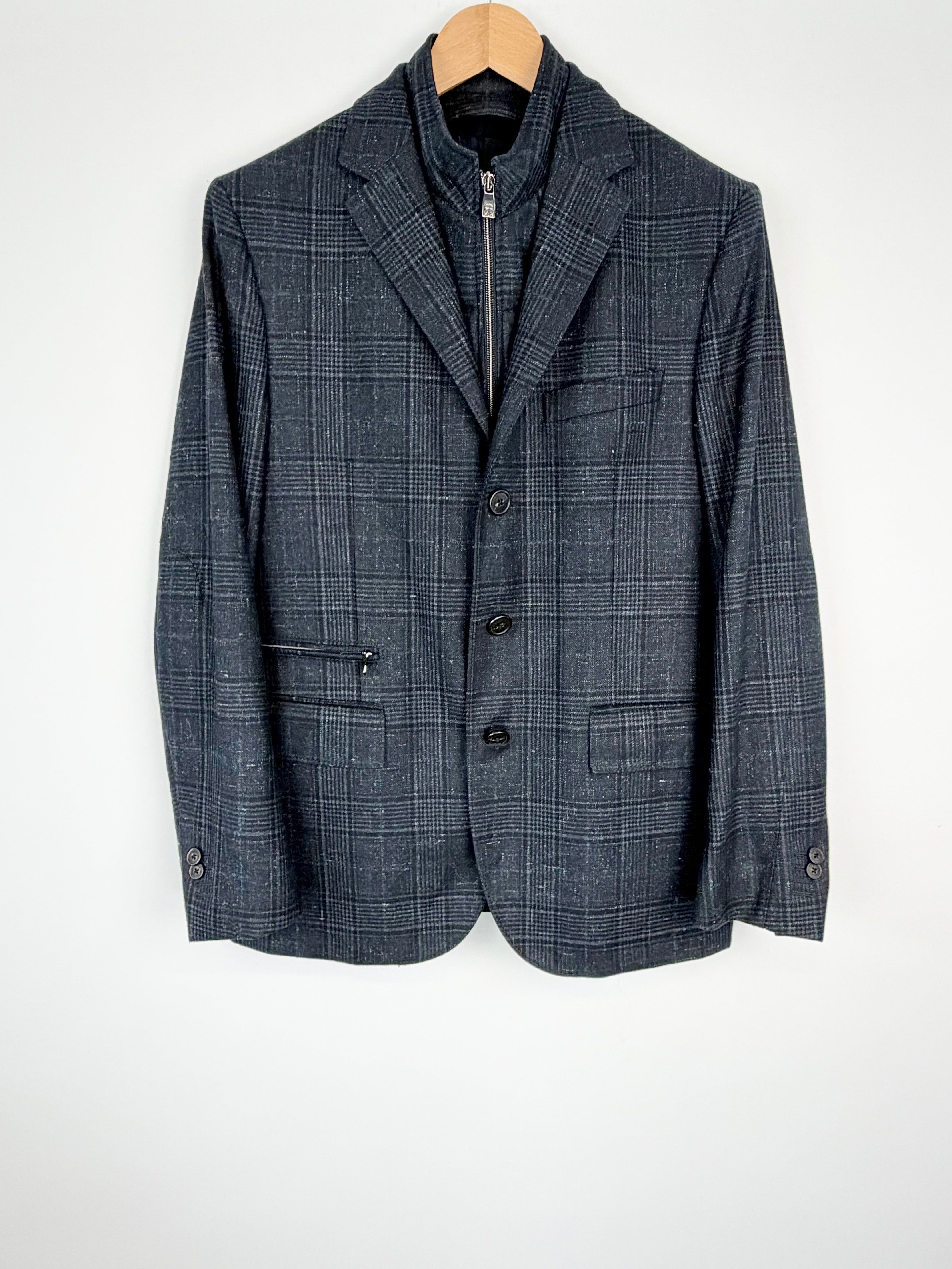 Gray checkered blazer on a hanger against a white background