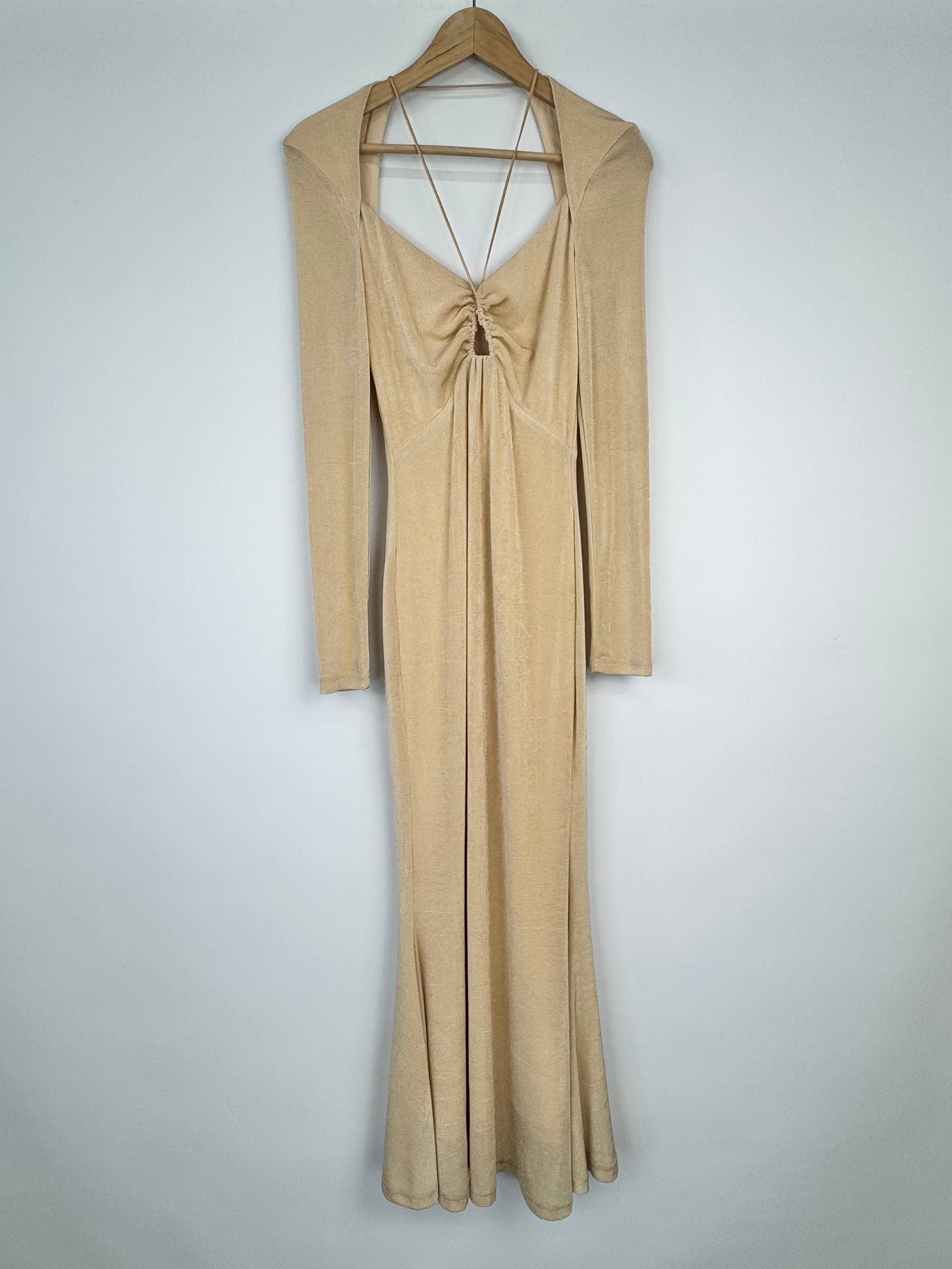 Beige long-sleeve dress on a hanger against a light gray background