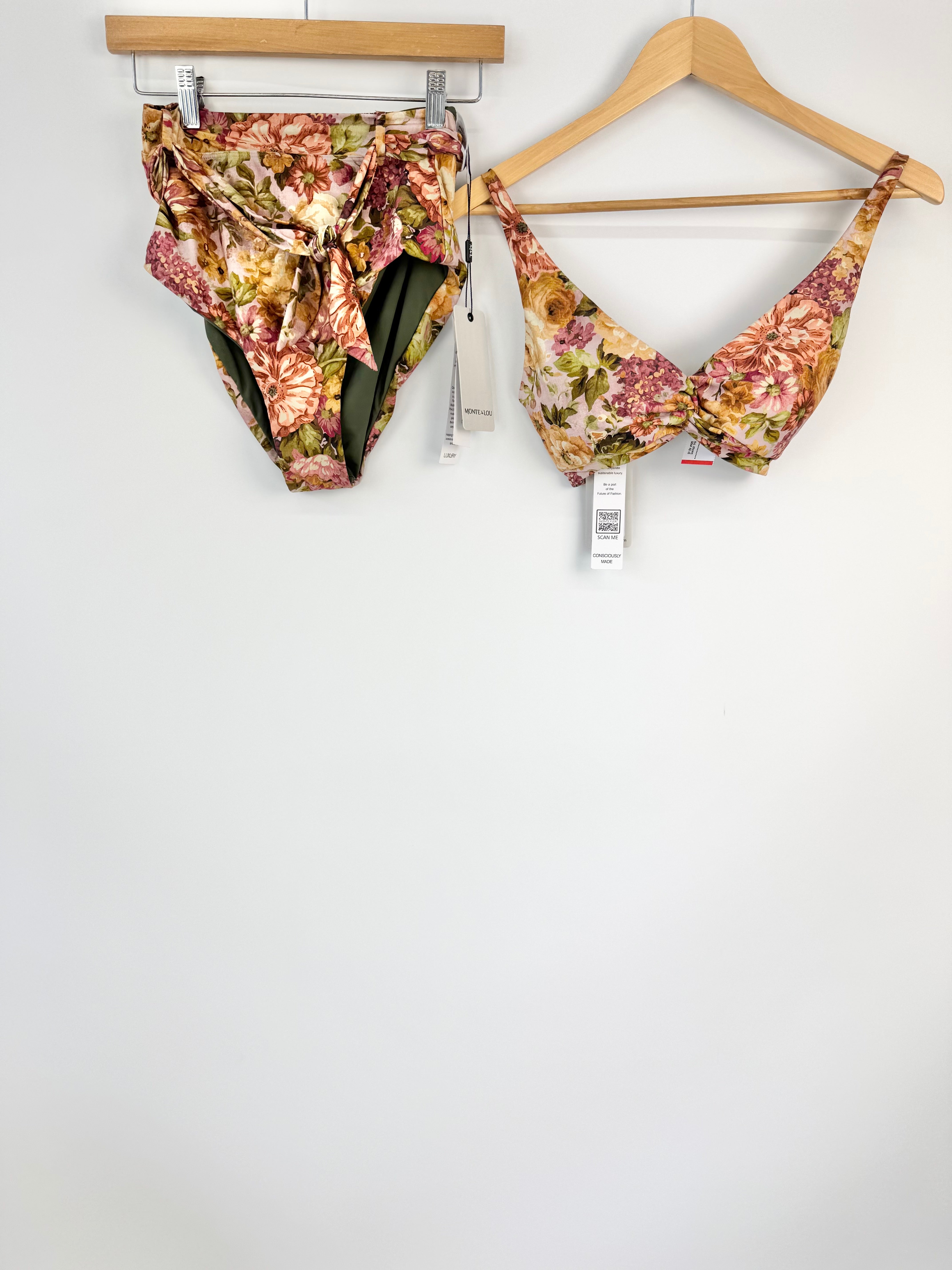Floral bikini set on hangers against a white background