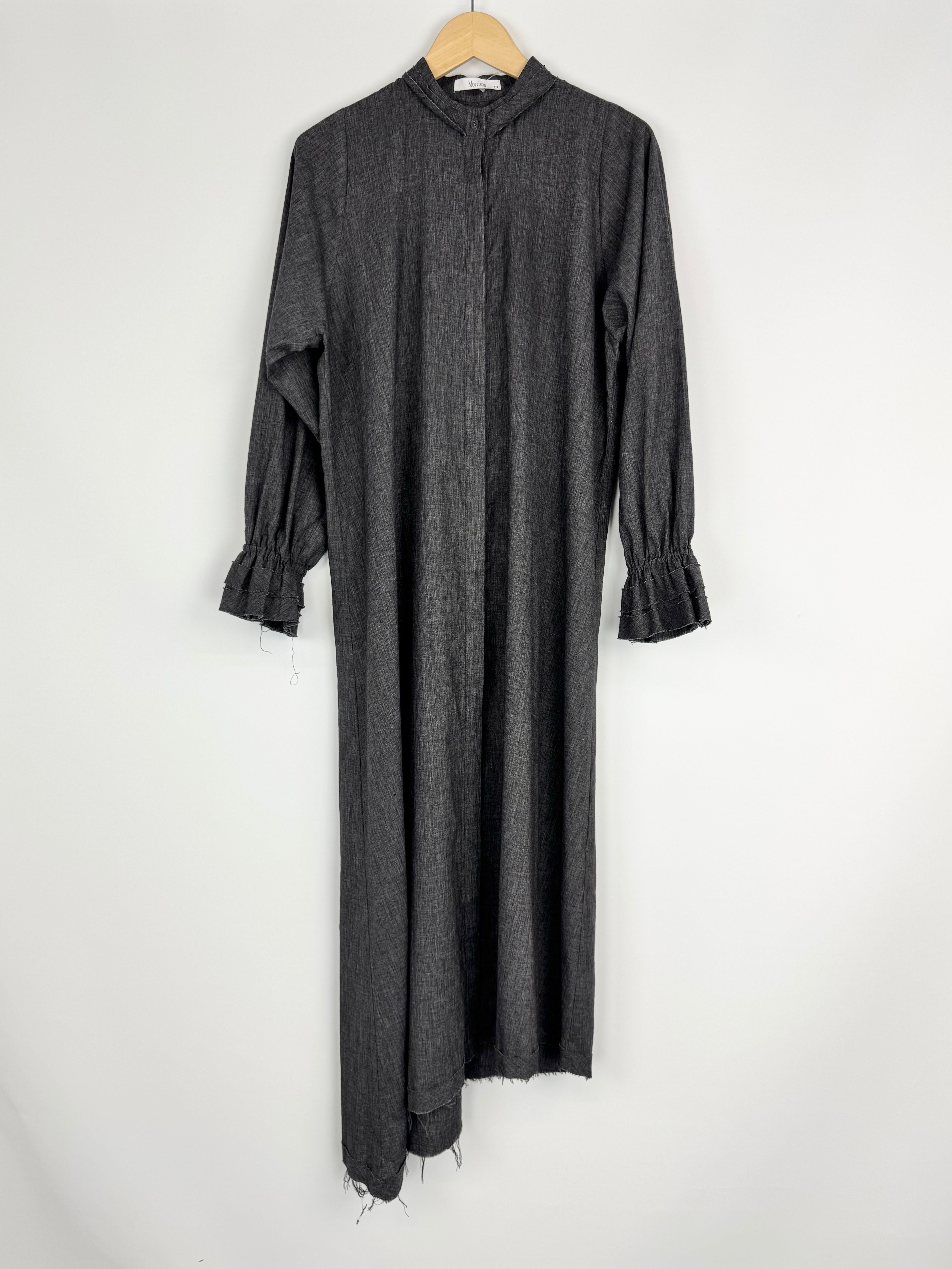 Long dark gray dress on a wooden hanger against a white background
