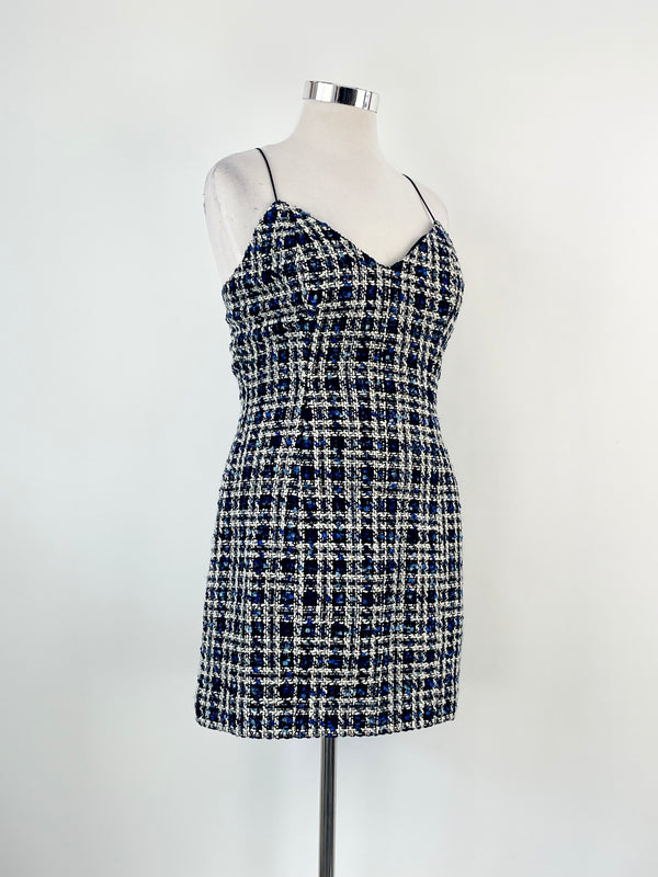 A navy and white checkered Mossman mini dress with thin straps and a V-neckline, displayed on a mannequin against a white background.