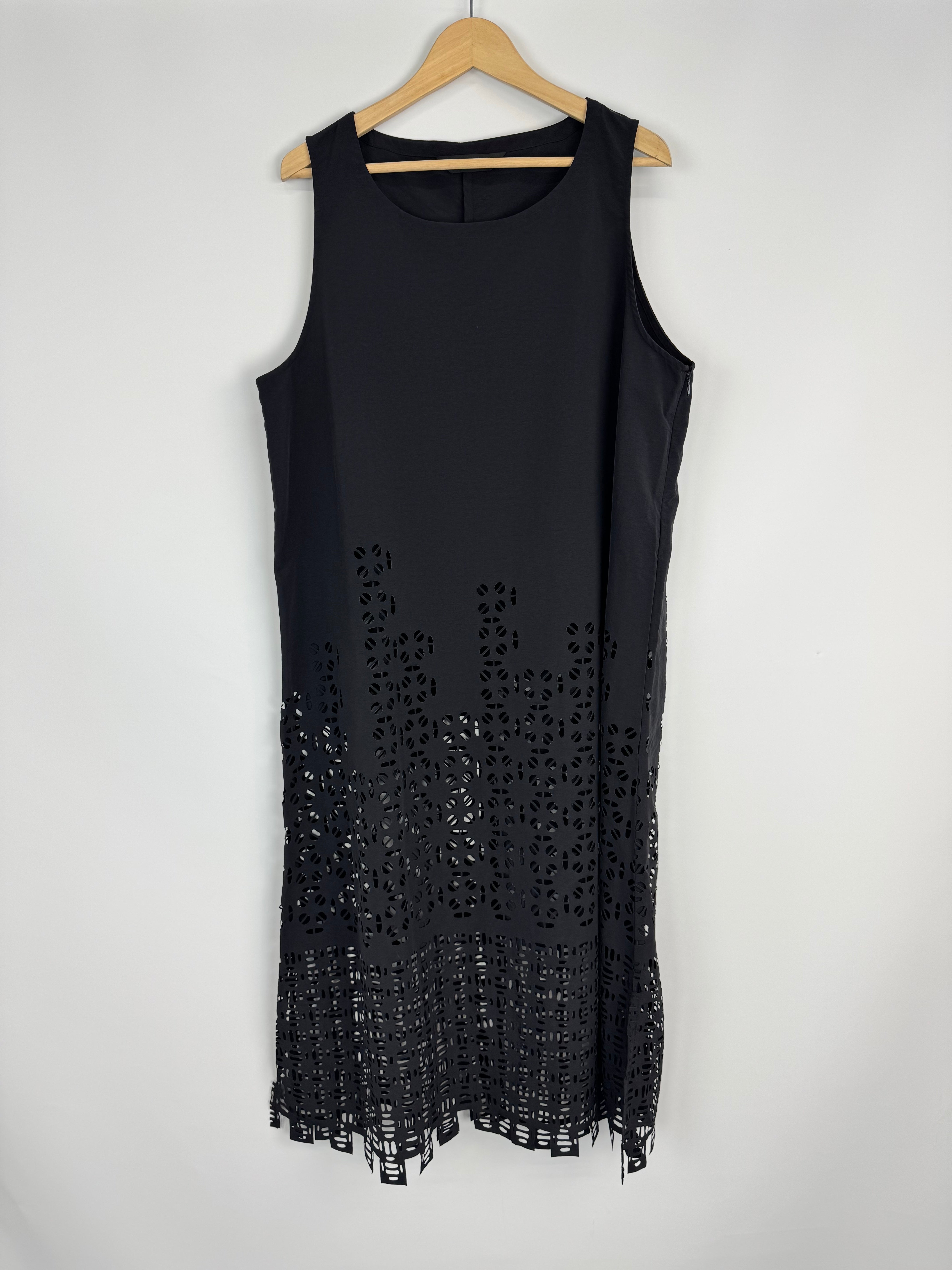 Black dress with cut-out details on a white background