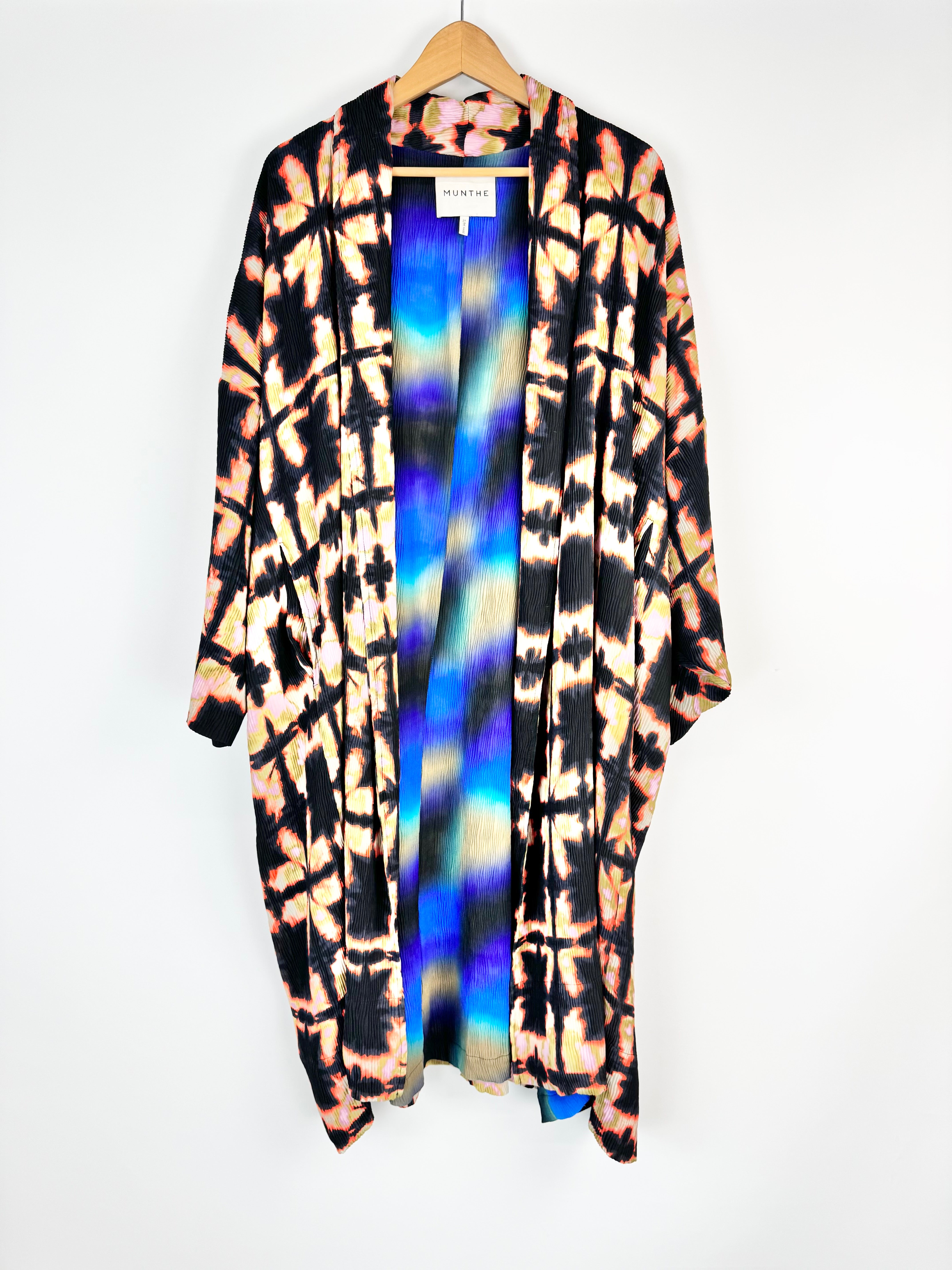 Tie-dye long cardigan on a hanger with a white background