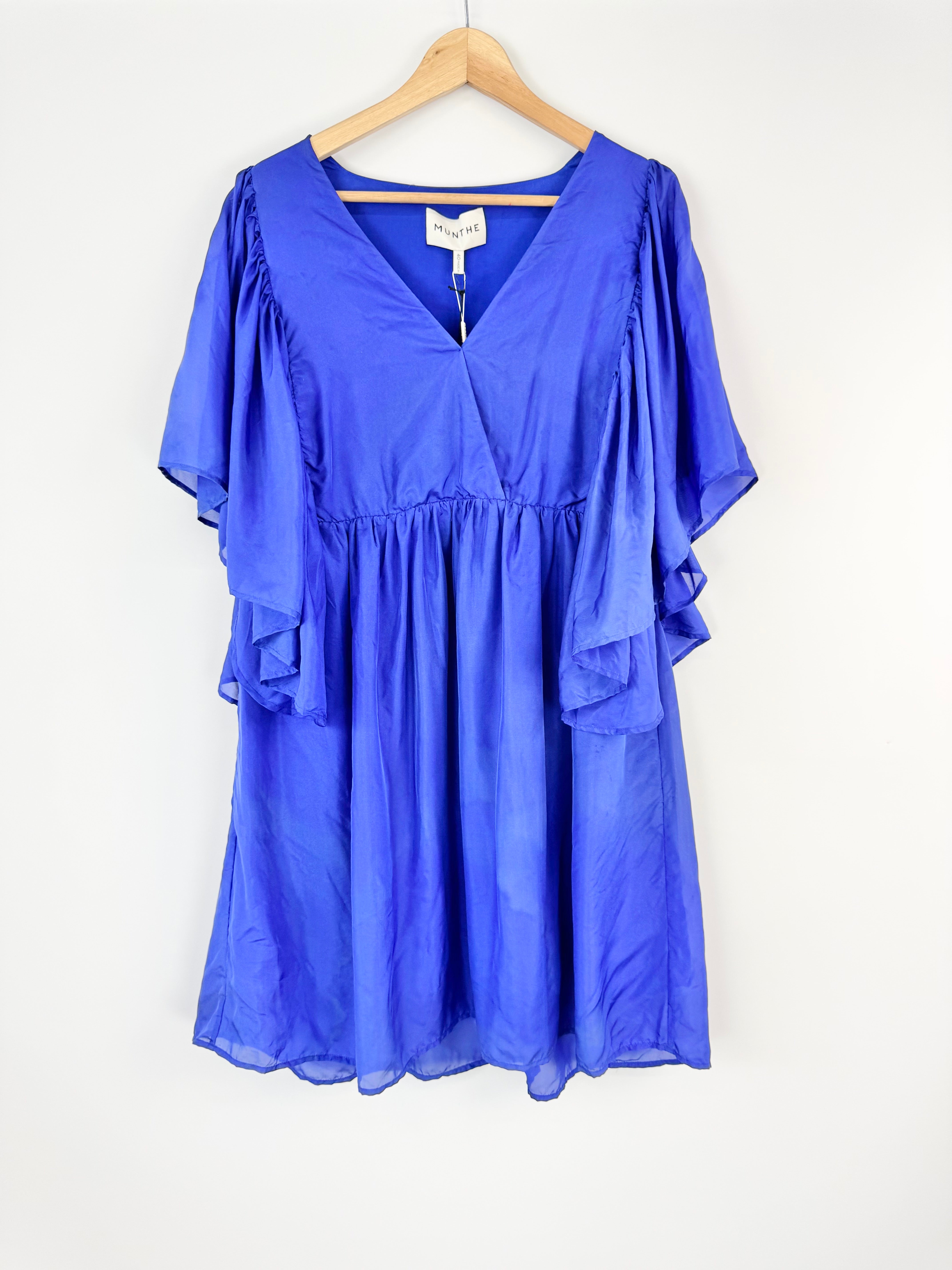 Blue dress on a hanger against a white background