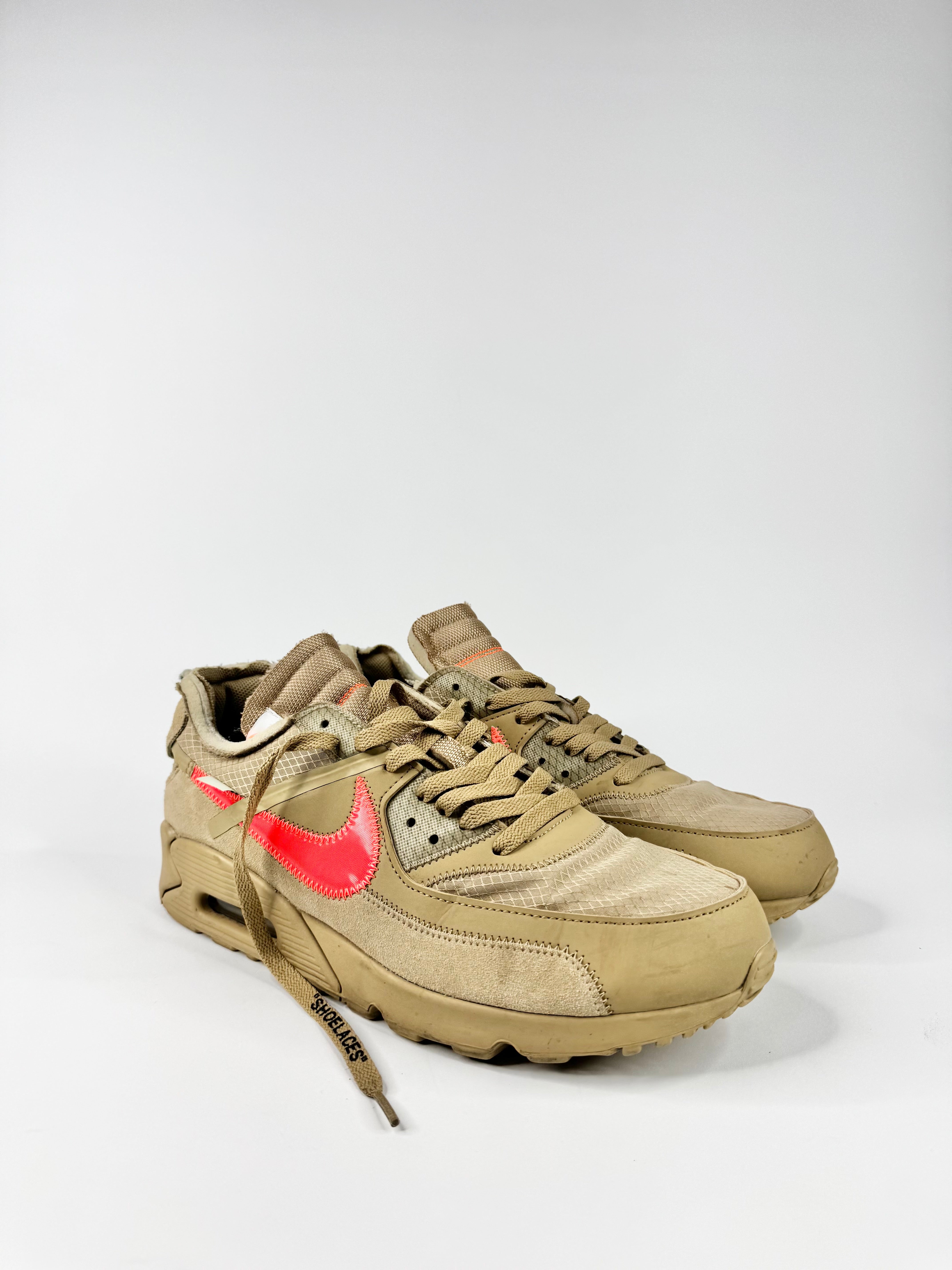 Beige sneakers with red accents on a white background
