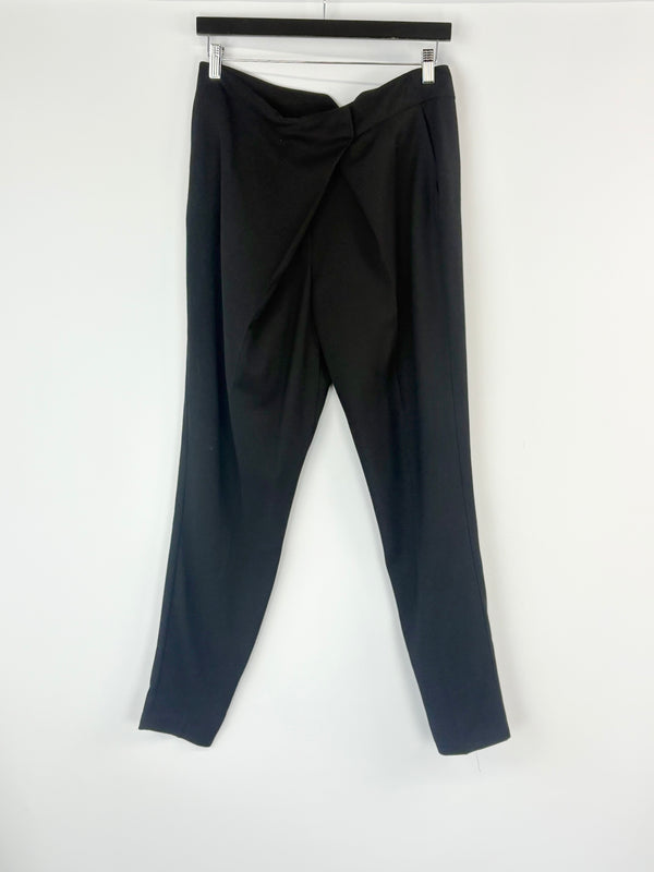Black pants with a draped design on a white background