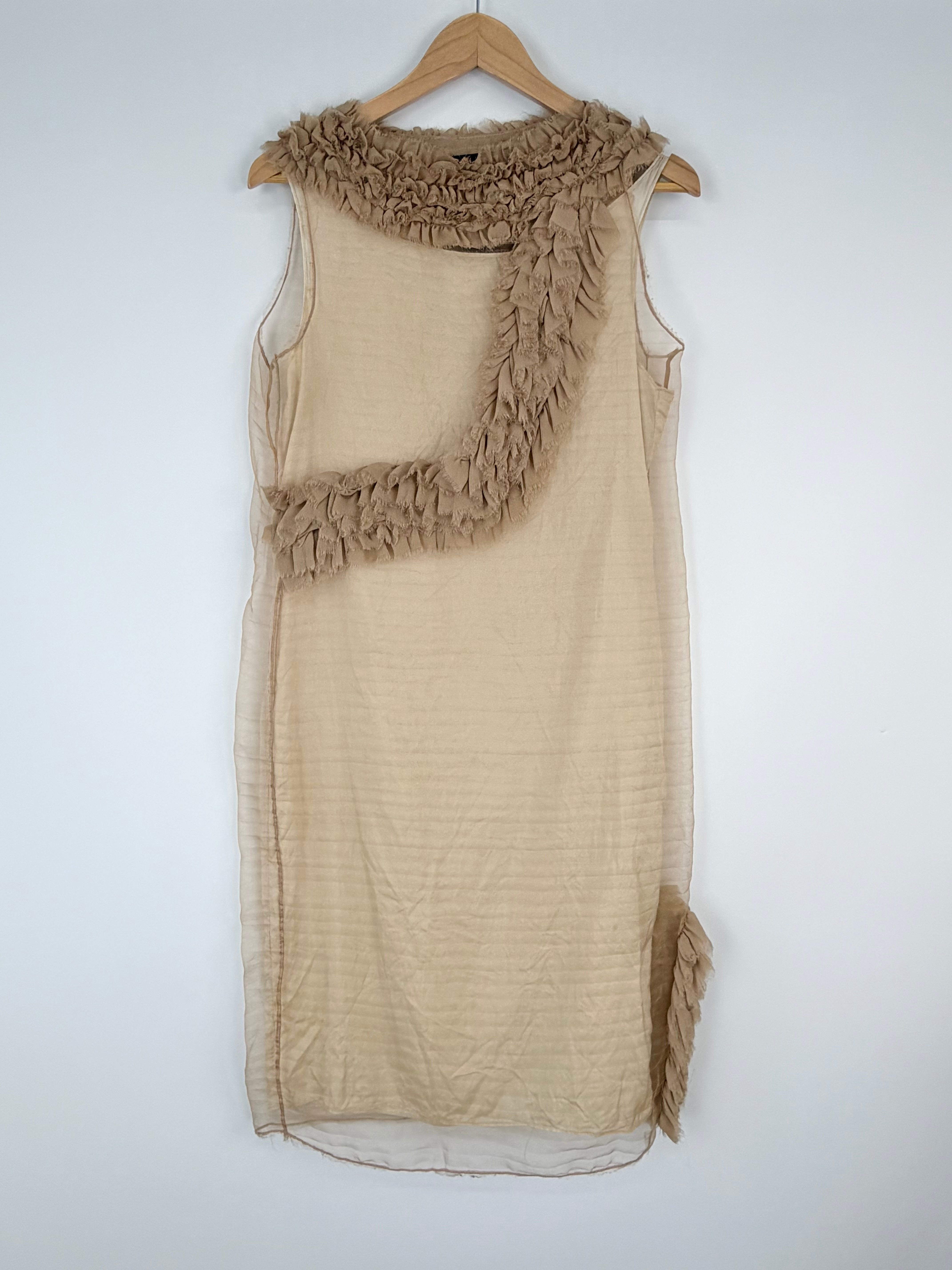 Beige sleeveless dress with ruffled details on a hanger against a white background