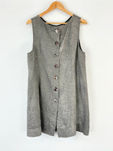 Gray sleeveless Nicola Waite button-up dress on a wooden hanger against a white background