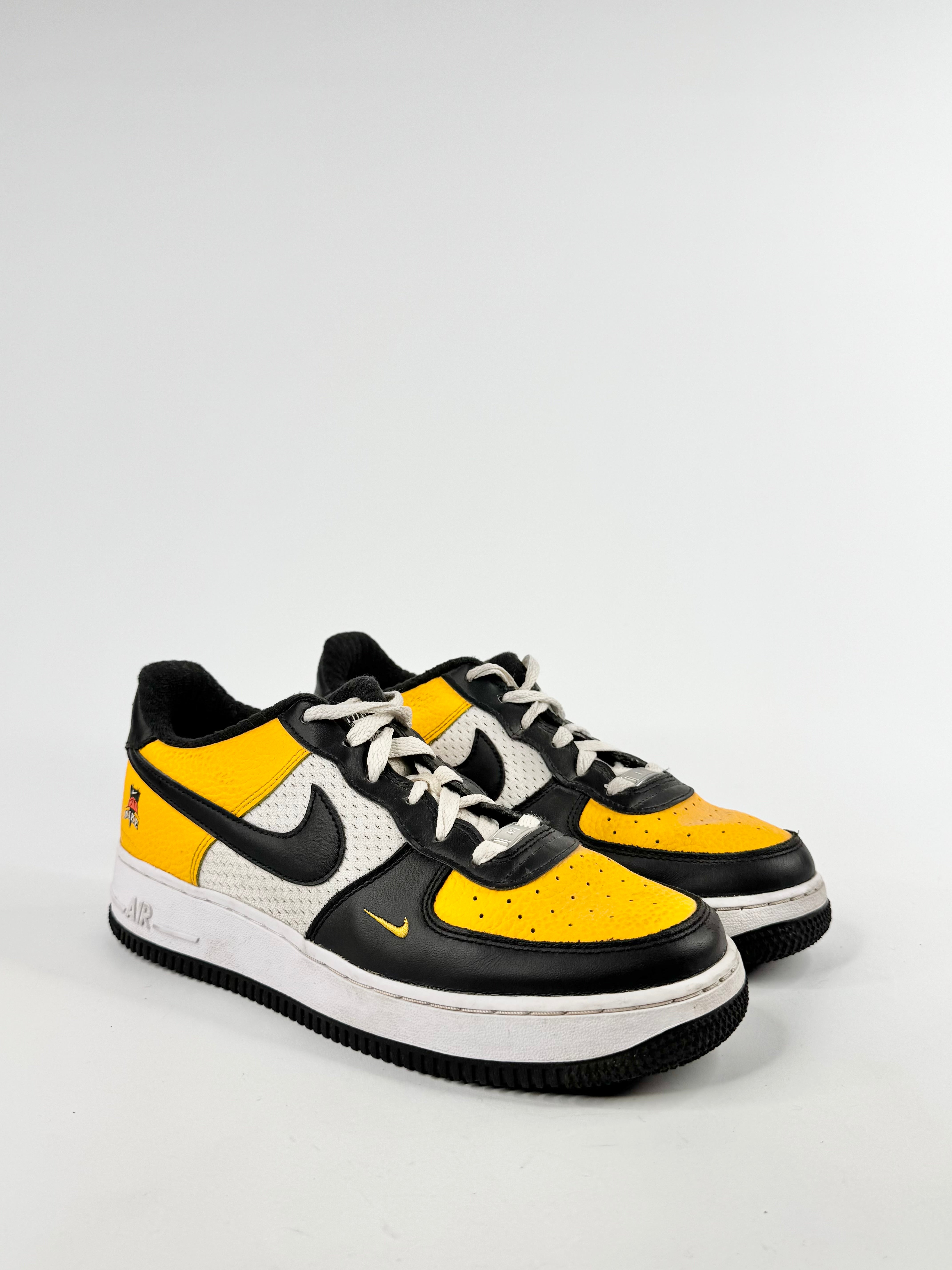 Black and yellow sneakers with a white background