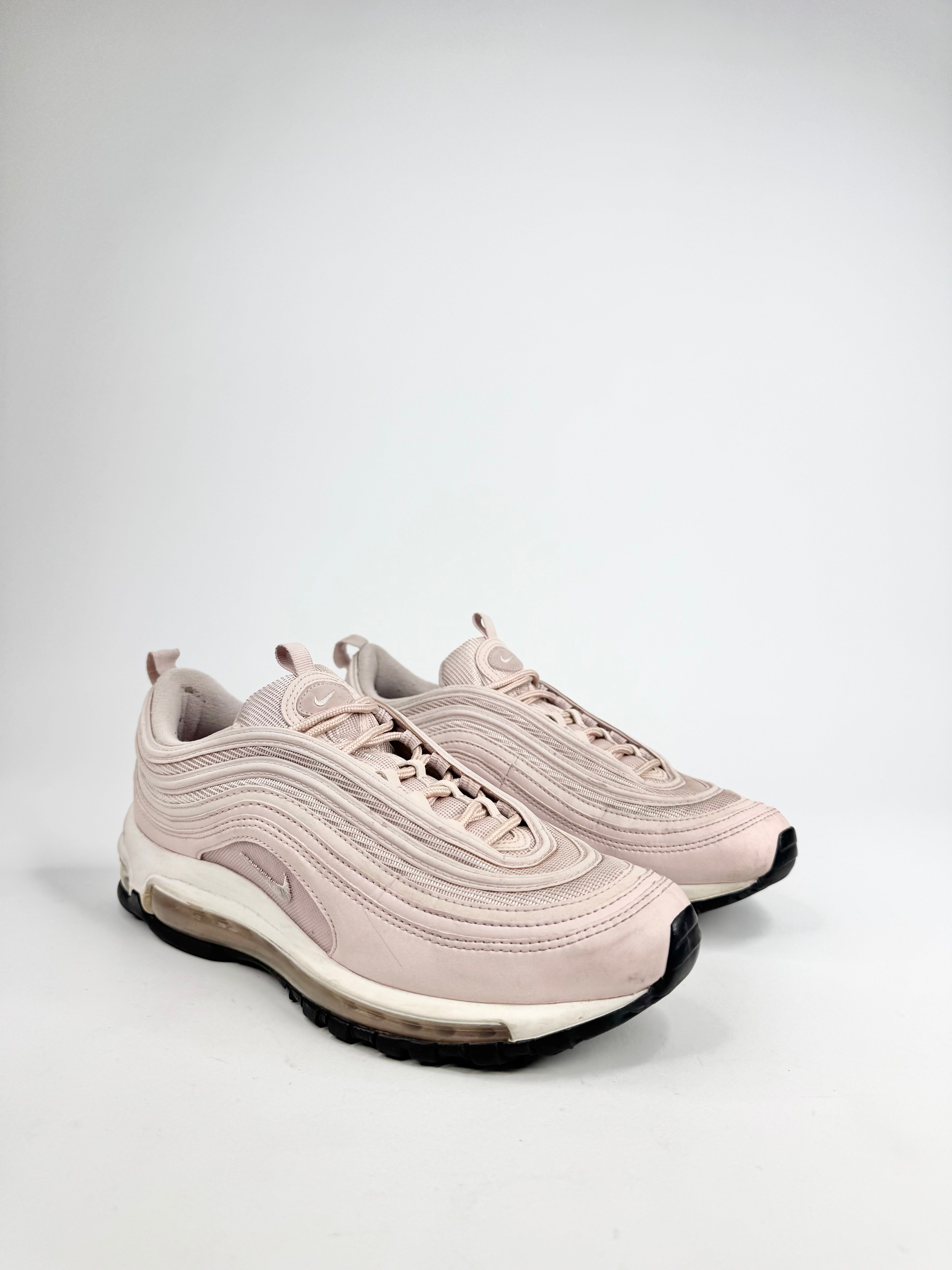 Pair of beige sneakers on a light gray background