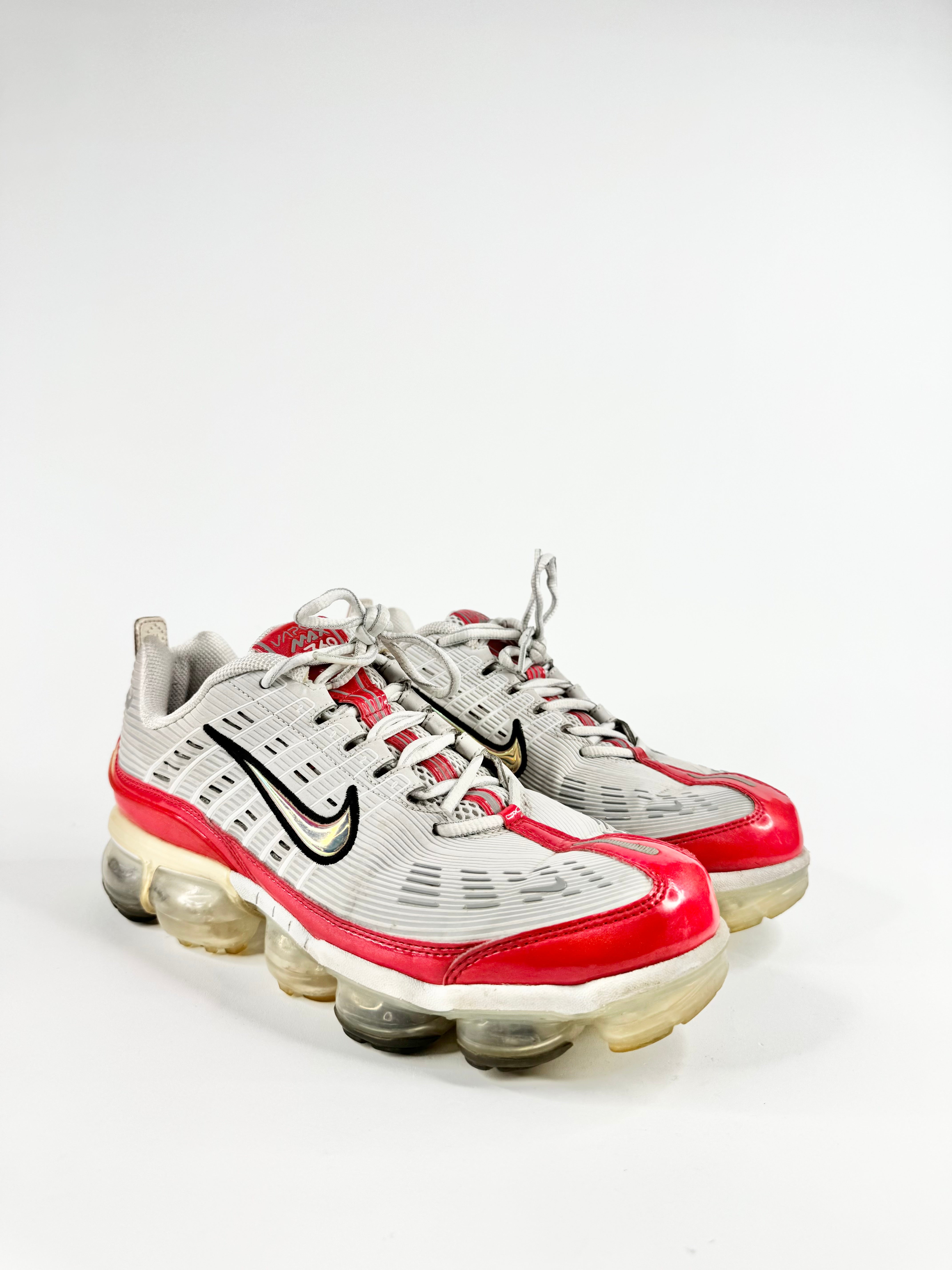 White and red sneakers with a visible brand logo on a white background