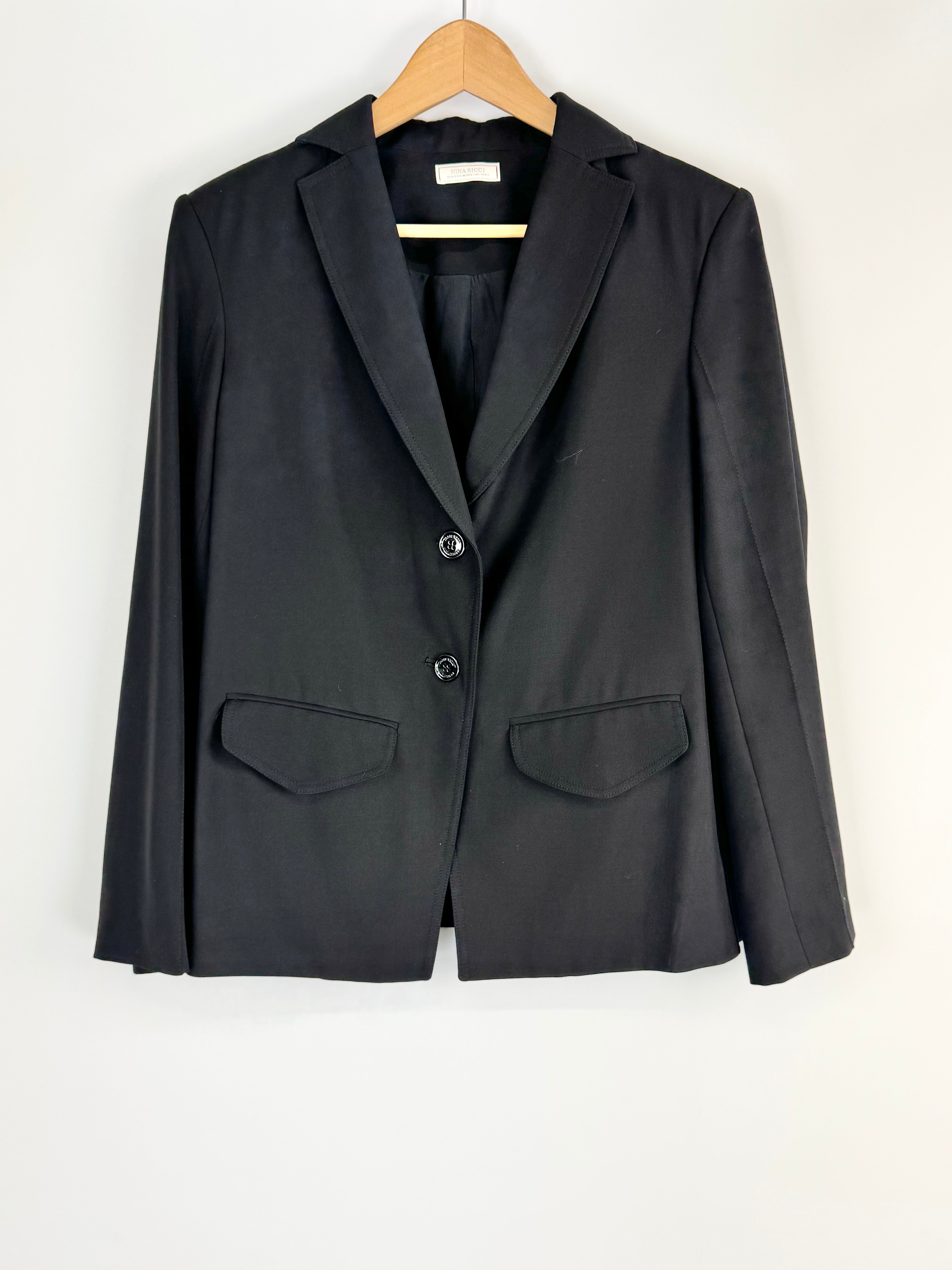 Black blazer on a wooden hanger against a white background