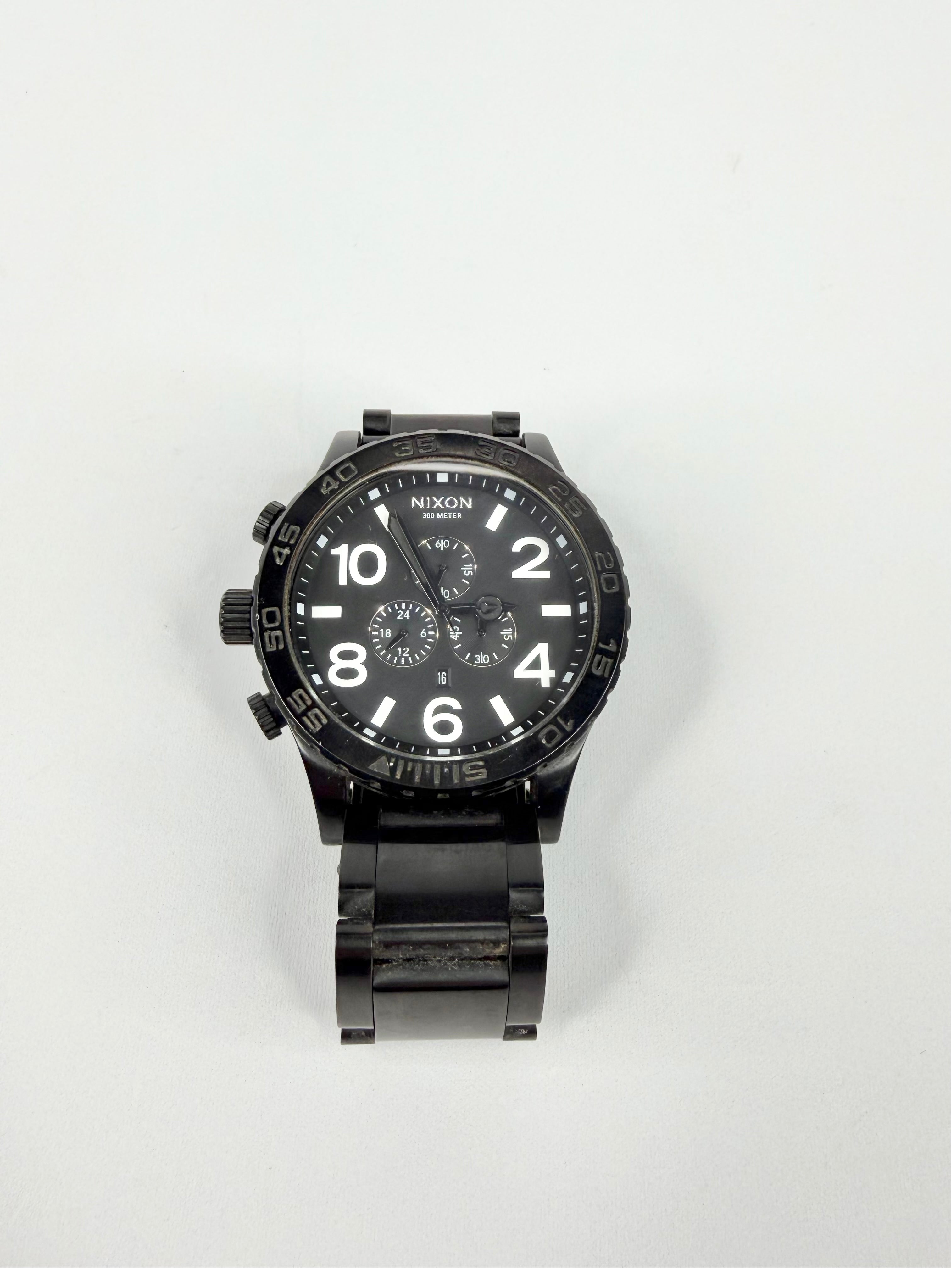 Black Nixon watch on a white background