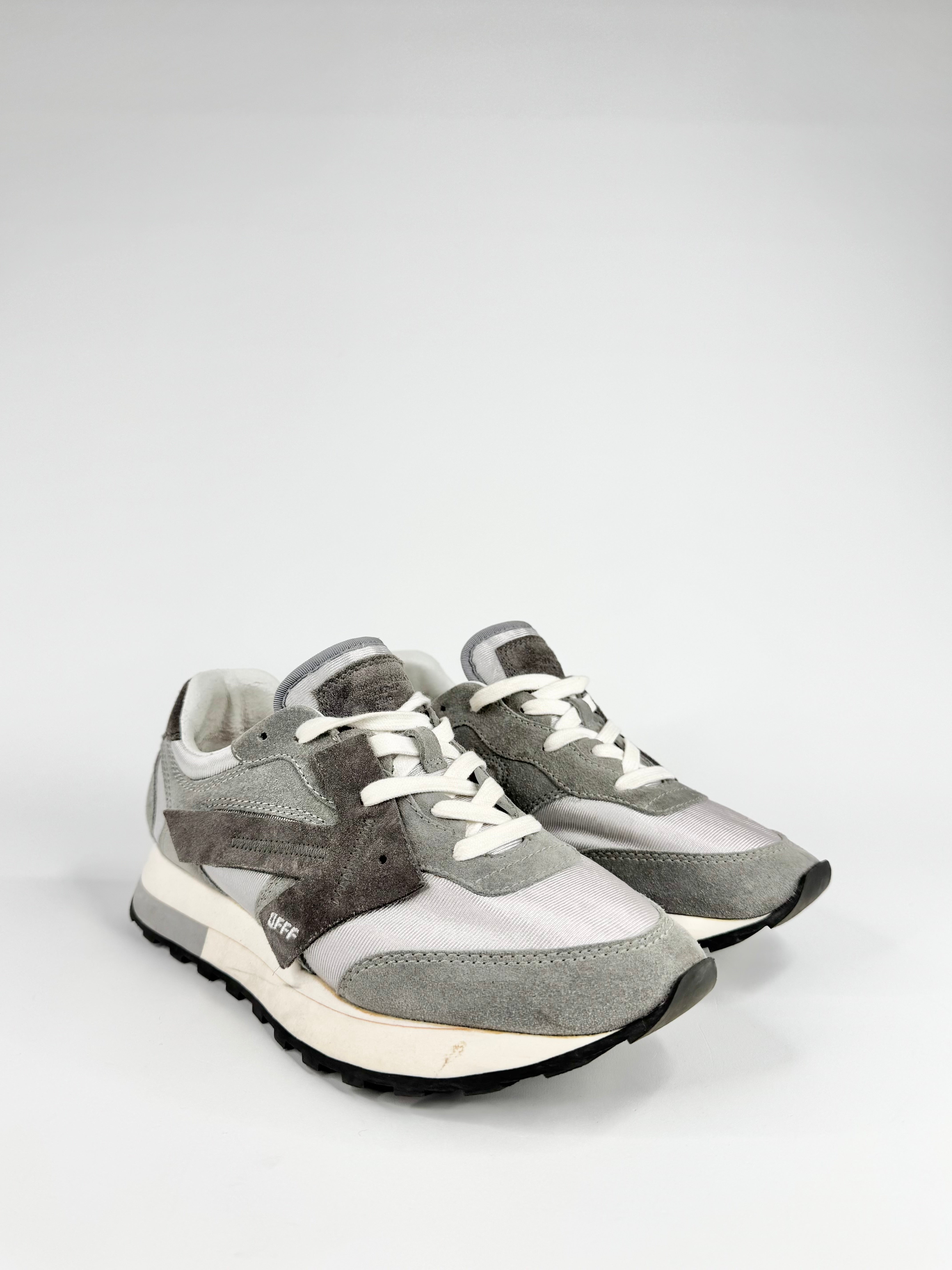 Pair of gray and white sneakers on a light gray background