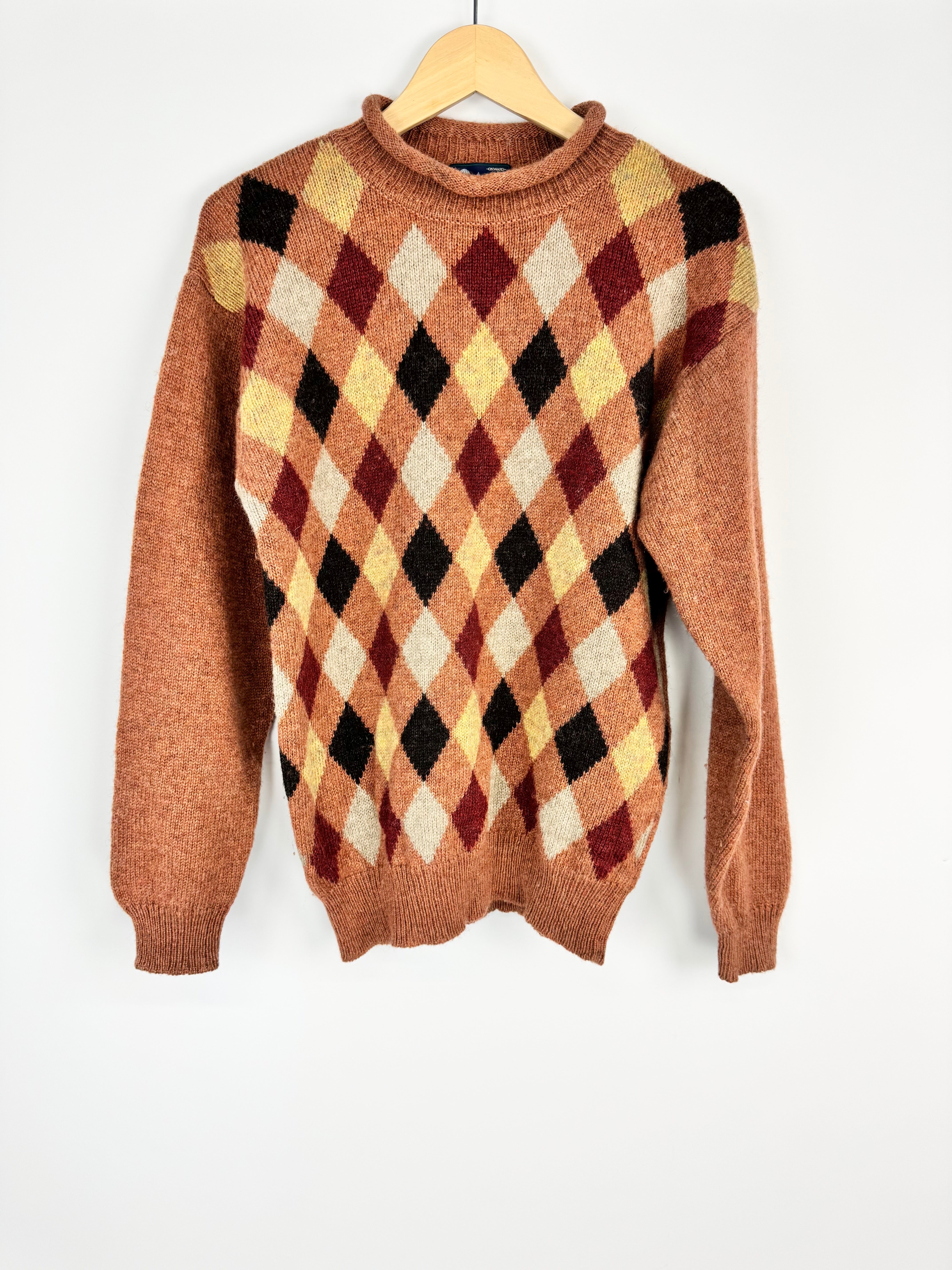 Brown argyle sweater on a hanger against a white background